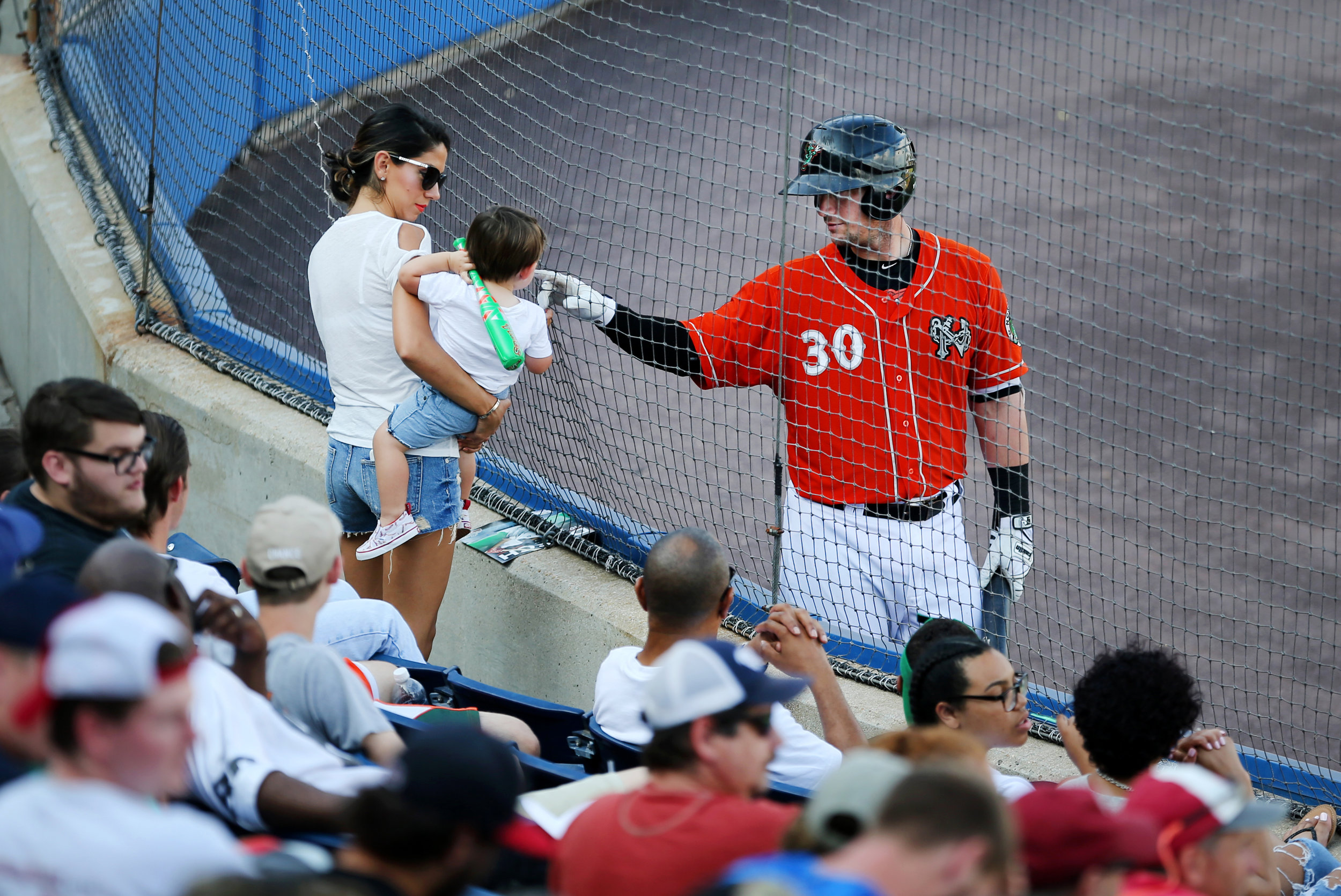 While on-deck, Norfolk's Chris Johnson greets his 18-month-old son Greyson and wife Tia in a 6-1 loss to Durham, Sunday, July 2, 2017 at Harbor Park in Norfolk.