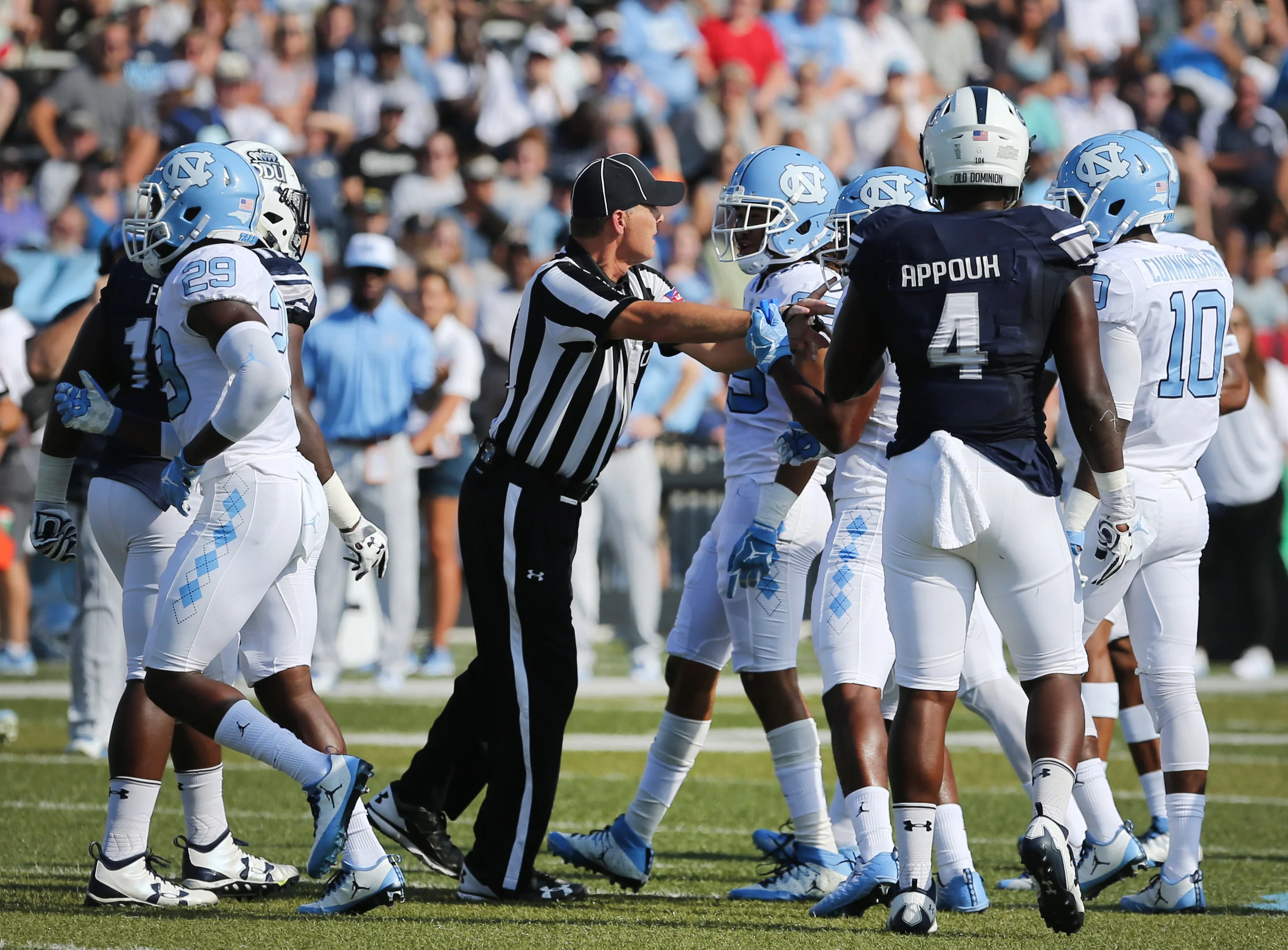 An official separates UNC and Old Dominion players after a skirmish in the second half football game, Saturday, Sept. 16, 2017 in Norfolk, Va.