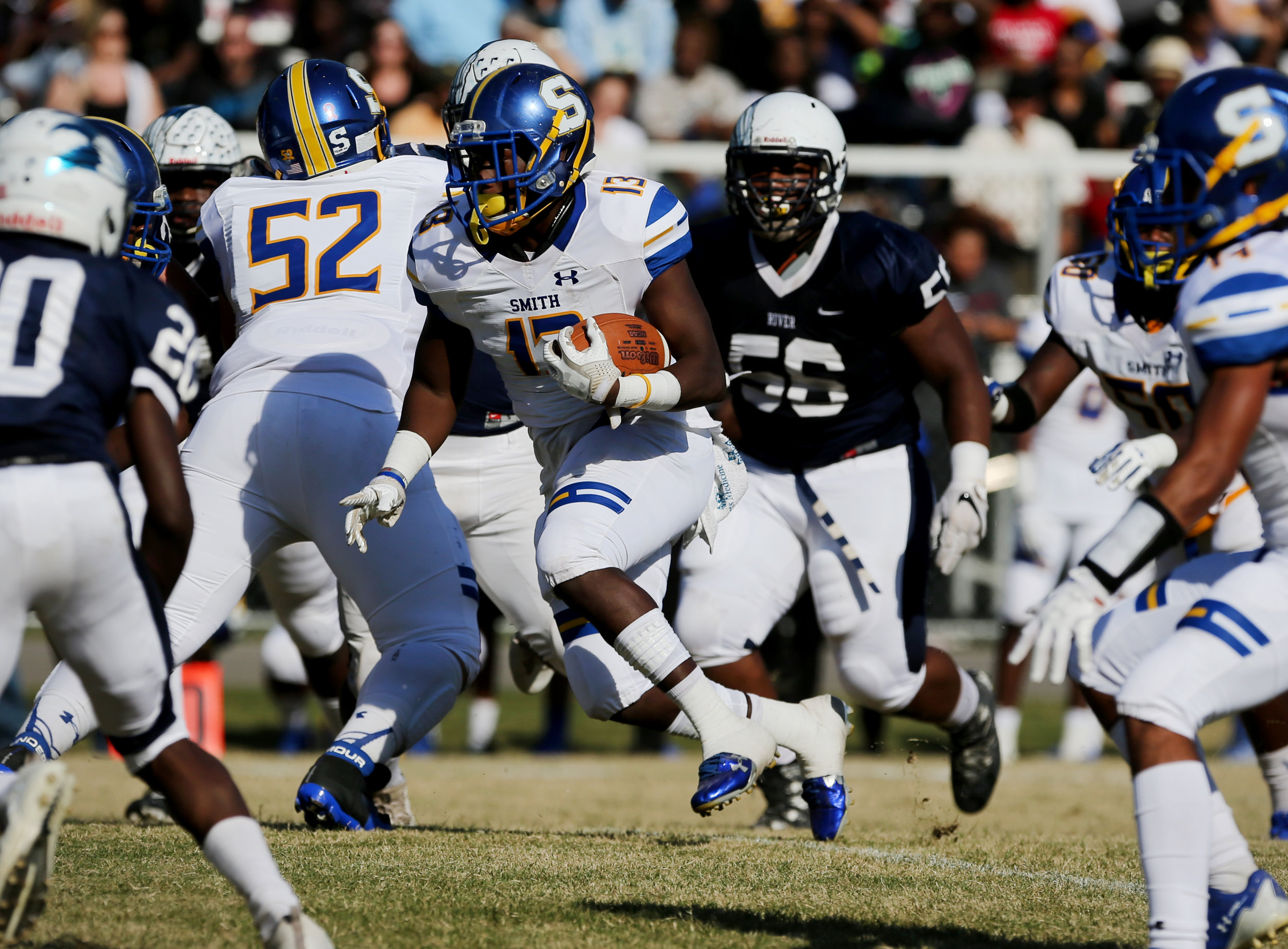 Oscar Smith's Deangelo White, center, finds room for a huge gain against the Indian River defense during the Tigers' 35-14 win, Saturday, Oct. 21, 2017 at Indian River High School in Chesapeake. 
