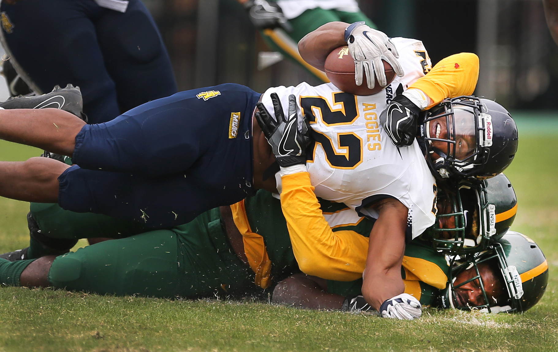 North Carolina A&T's Marquell Cartwright is brought down by Hadji Gaylord as teammate Anton Ashby is pancaked at the bottom during the Spartans' 35-7 loss, Saturday, Nov. 4, 2017 at Dick Price Stadium in Norfolk.