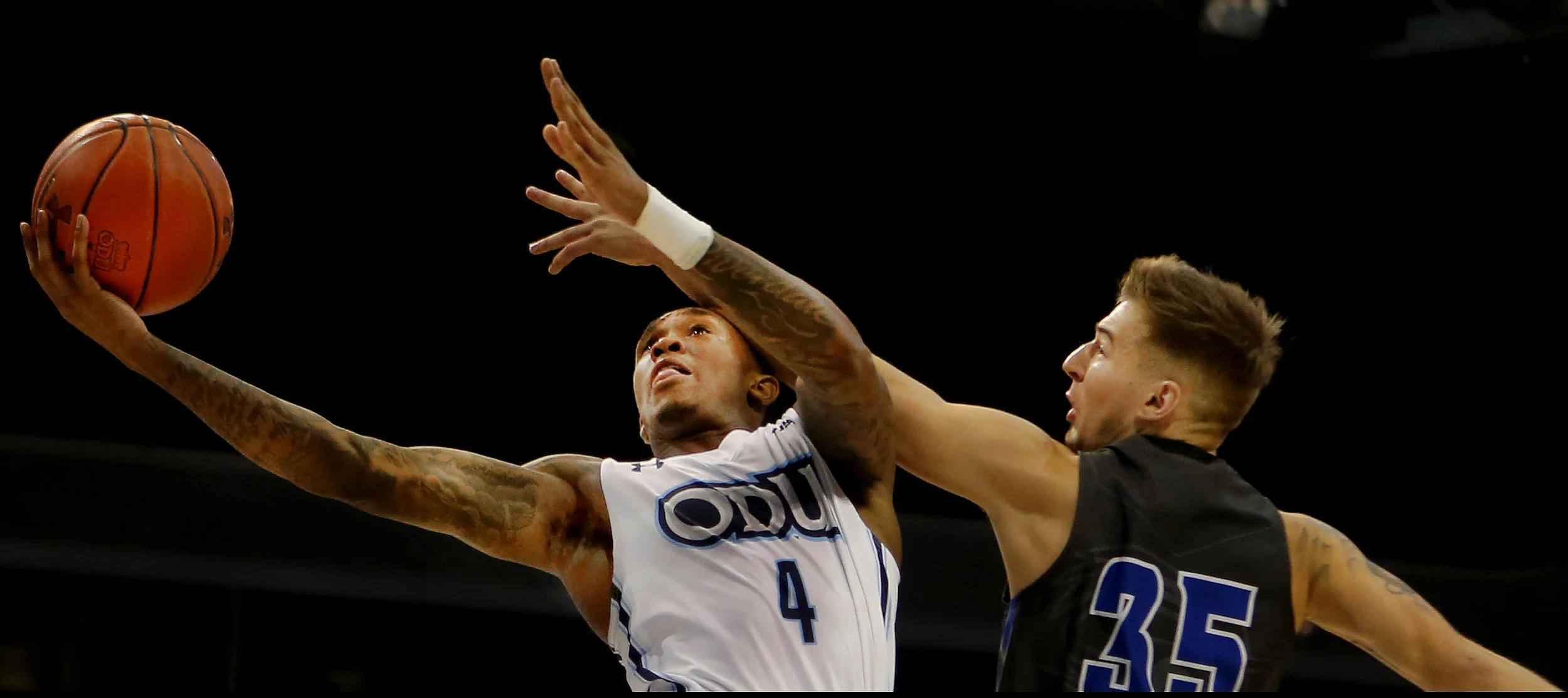 Old Dominion's Ahmad Caver shoots past Christopher Newport's Brock Geiman during the Monarchs' 101-46 exhibition win, Sunday, Nov. 5, 2017 at the Constant Center in Norfolk. 