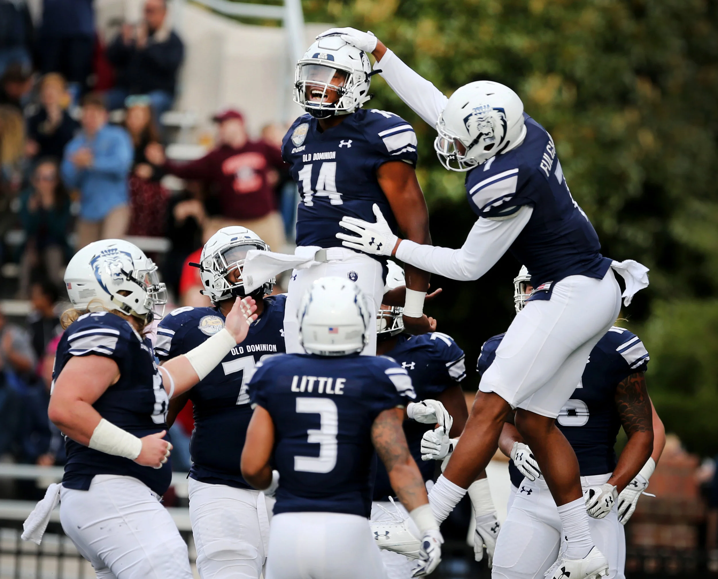 Old Dominion players celebrate with Steven Williams, Jr., center, after Williams ran the ball in on a quarterback keeper play for the first touchdown against Rice, Saturday, Nov. 18, 2017 at Foreman Field in Norfolk. 