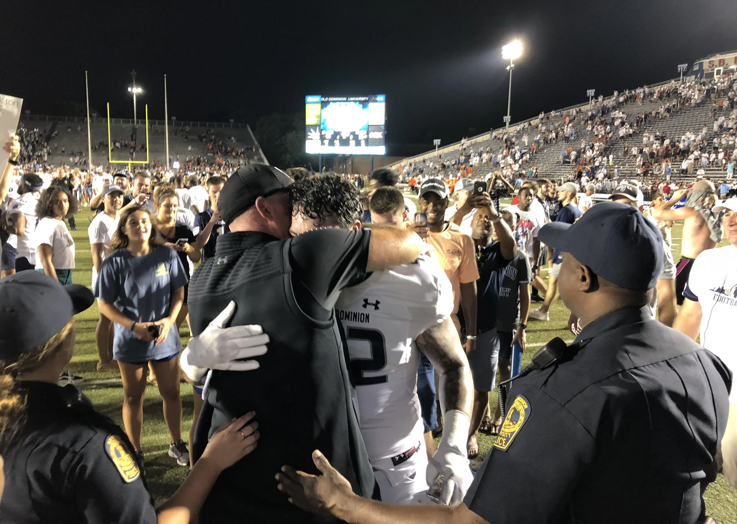 Old Dominion head football coach Bobby Wilder embraces his son Derek Wilder after an NCAA college football game Saturday, Sept. 22, 2018, in Norfolk, Va. Old Dominion won 49-35. (AP Photo/Jason Hirschfeld)
