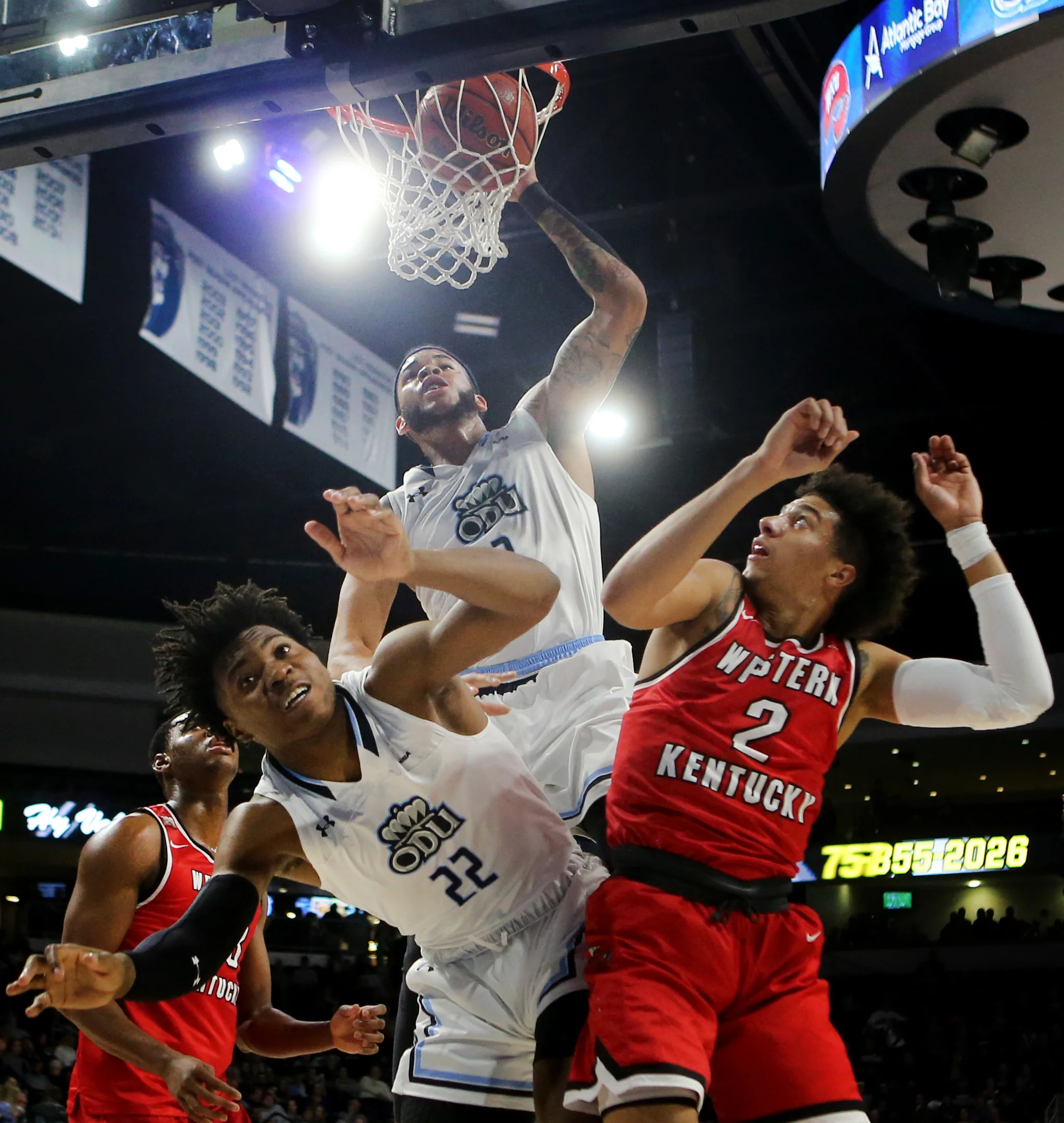 Old Dominion's B.J. Stith dunks the ball over the backs of teammate Kalu Ezikpe, left, and Western Kentucky's Jared Savage during the first half, Saturday, January 5, 2019 at the Constant Center in Norfolk.