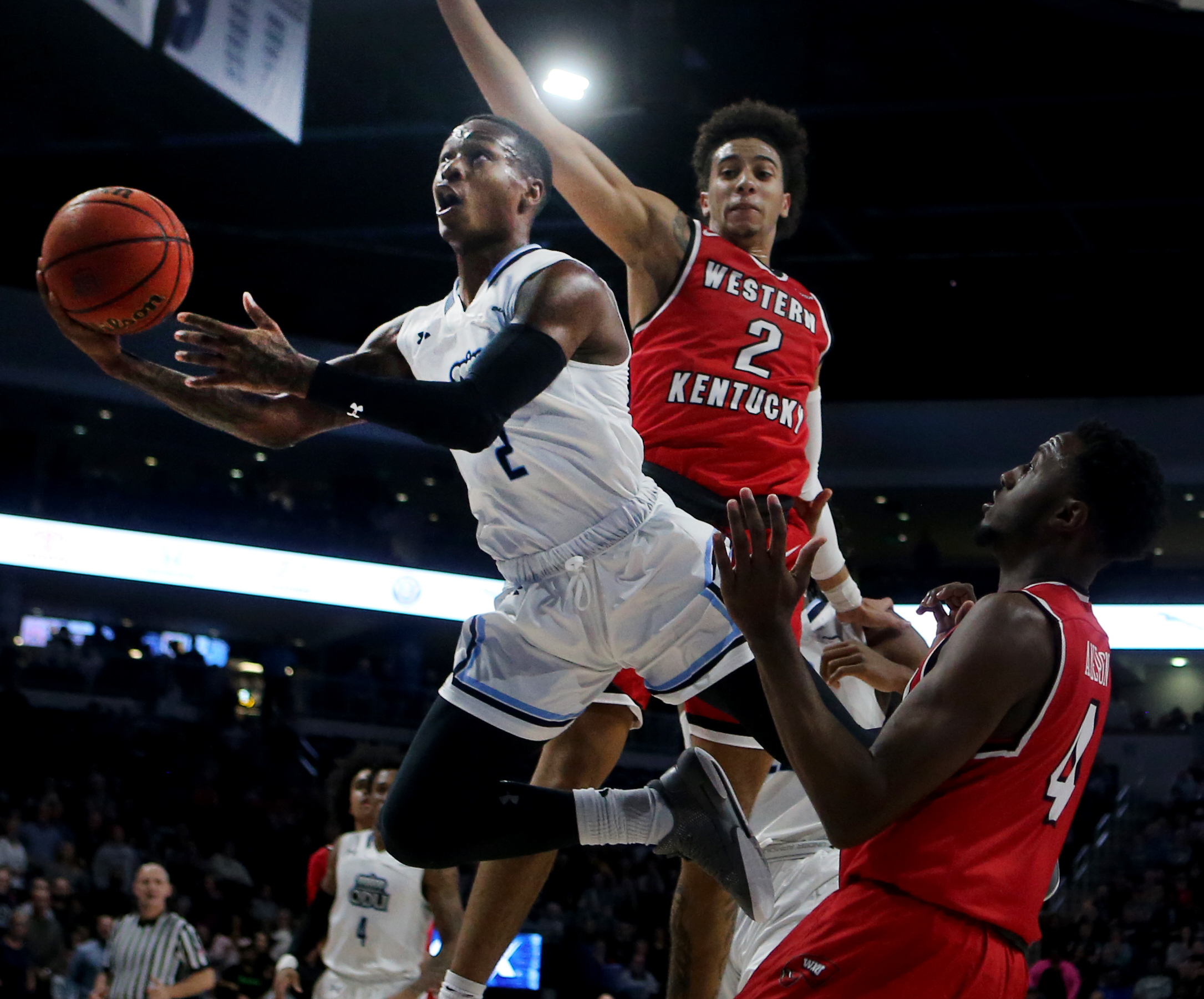 Old Dominion's Justice Kithcart slices through Western Kentucky defenders Jared Savage, center, and Josh Anderson, right, during the first half, Saturday, January 5, 2019 at the Constant Center in Norfolk.