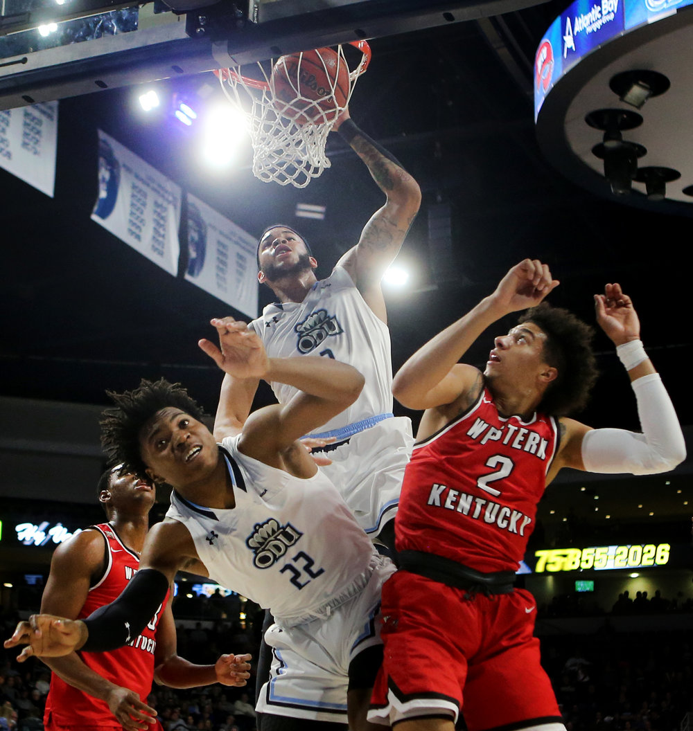Old Dominion's B.J. Stith dunks the ball over the backs of teammate Kalu Ezikpe, left, and Western Kentucky's Jared Savage during the first half at the Constant Center in Norfolk.