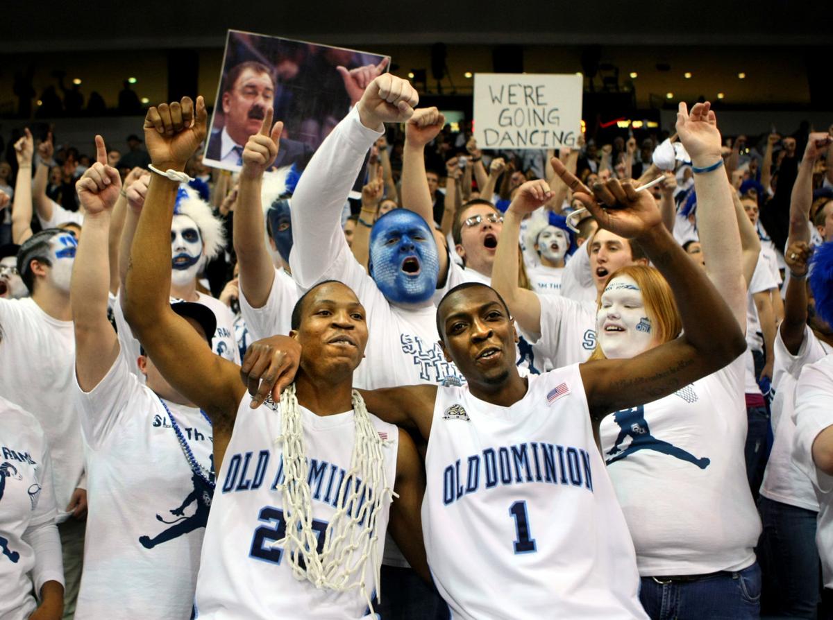 ODU's Marsharee Neely, left, and teammate Nick Wright celebrate in the student section after knocking off VCU 73-70 to claim the CAA regular season championship.