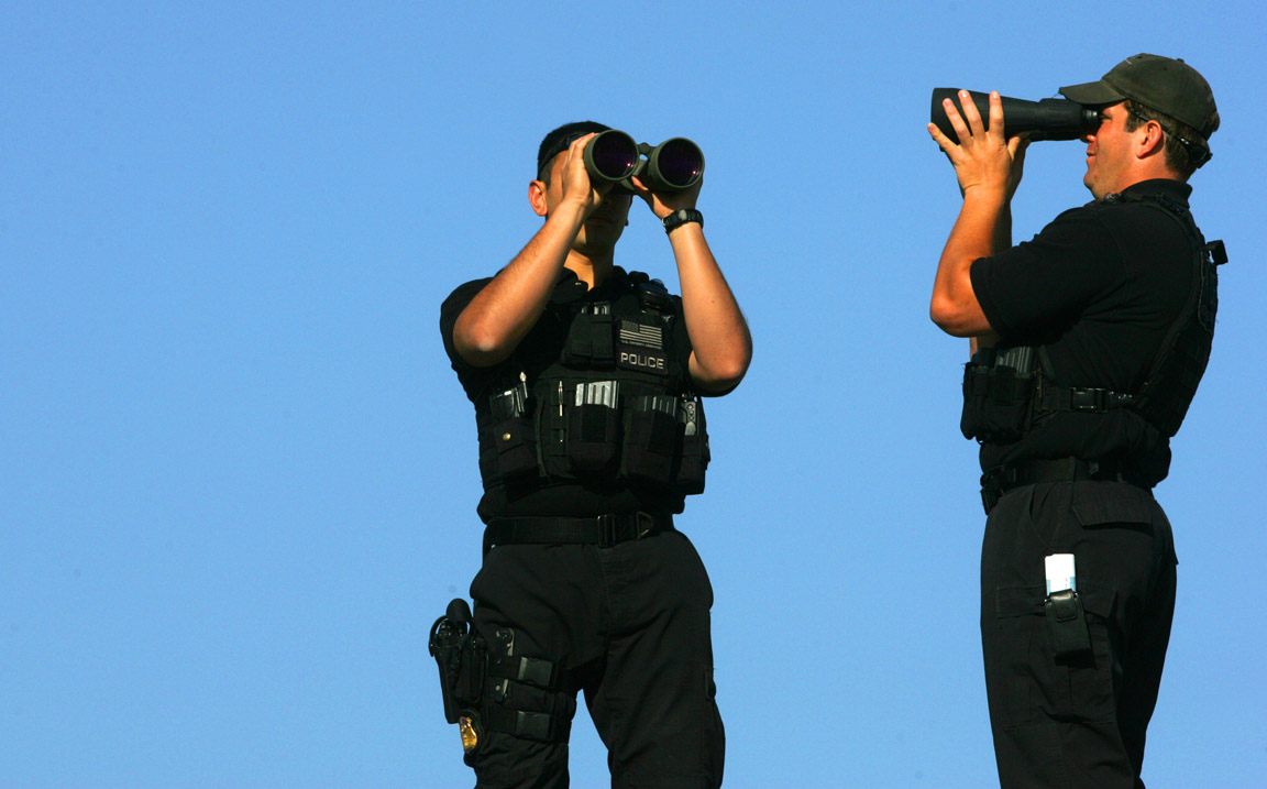 Secret Service officers scan the area from an above platform during an Obama campaign stop in Virginia Beach, Va.