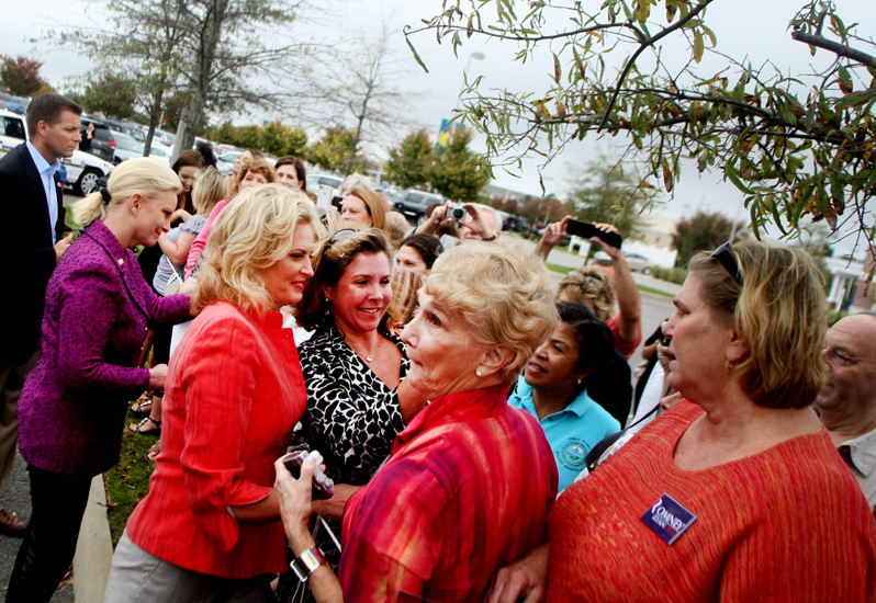 Ann Romney, left in red, and Cindy McCain, far left in purple, greet supporters during a campaign stop, Friday, Oct. 26, 2012 in Virginia Beach.