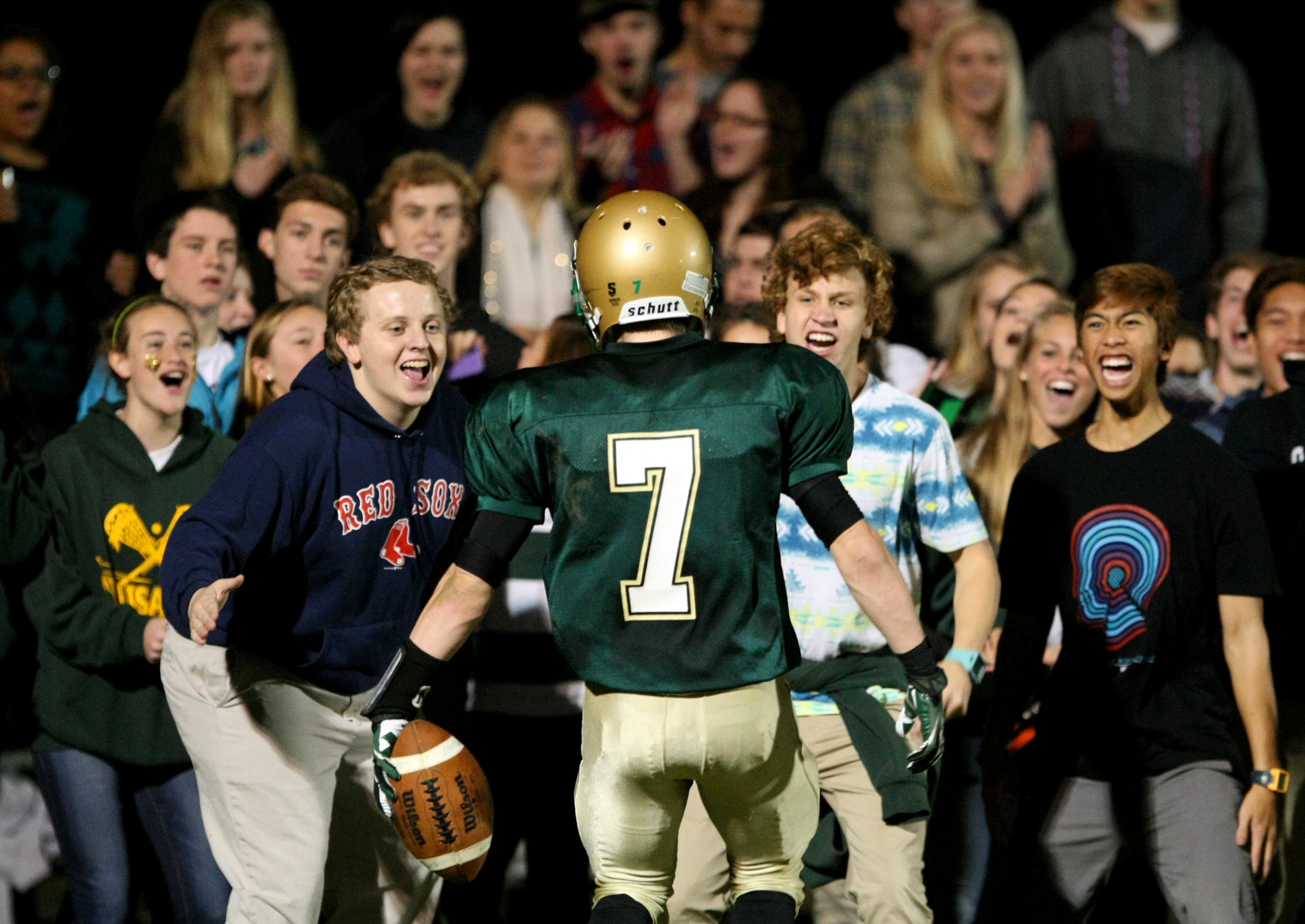 Bishop Sullivan's Liam Korka celebrates with the student section after scoring a second-quarter touchdown while playing Potomac School in the VISAA Division II state championship game, Saturday, Nov. 16, 2013 at Bishop Sullivan Catholic School in Virginia Beach. Bishop Sullivan won 50-44.
