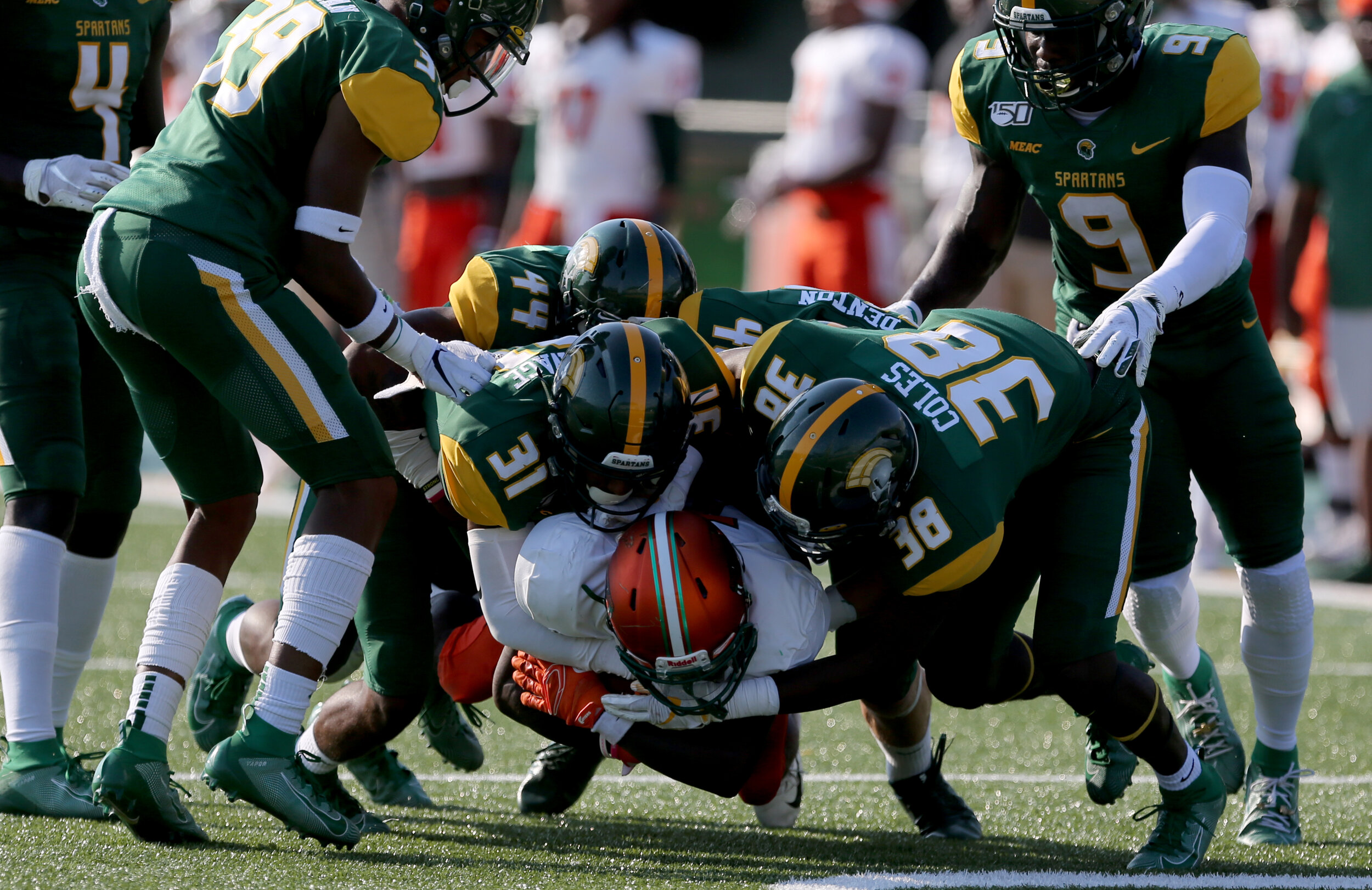 Norfolk State defenders Brandon Savage (31) and Devyn Coles (38) stuff Florida A&M's George Webb during third quarter action of the Spartans' 28-30 loss, Saturday, September 28, 2019 at Dick Price Stadium in Norfolk.