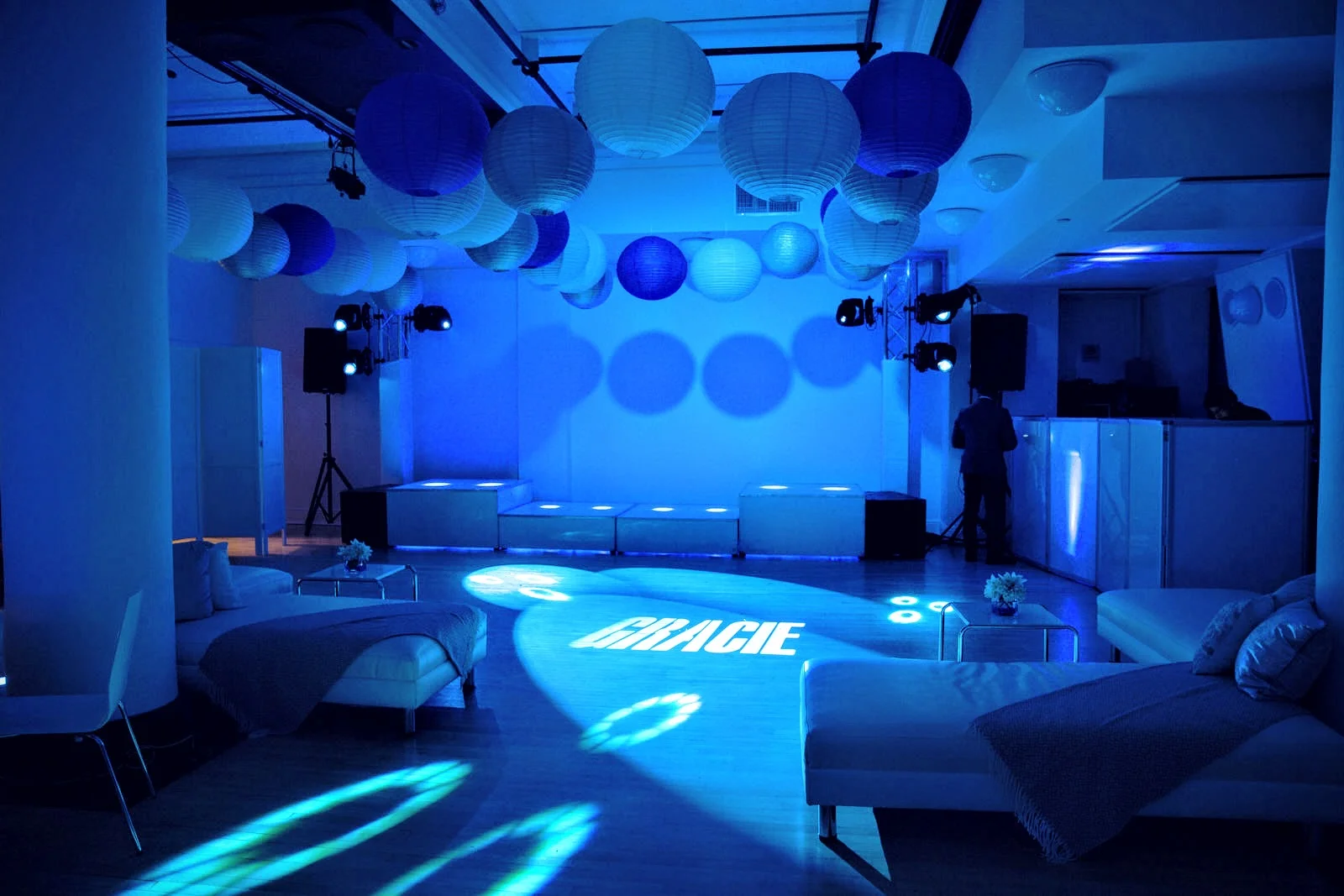 The dance floor featured paper lanterns, gobos, and LED - raised platform, lounge ottomans, and more. Photo by Art Photographers.