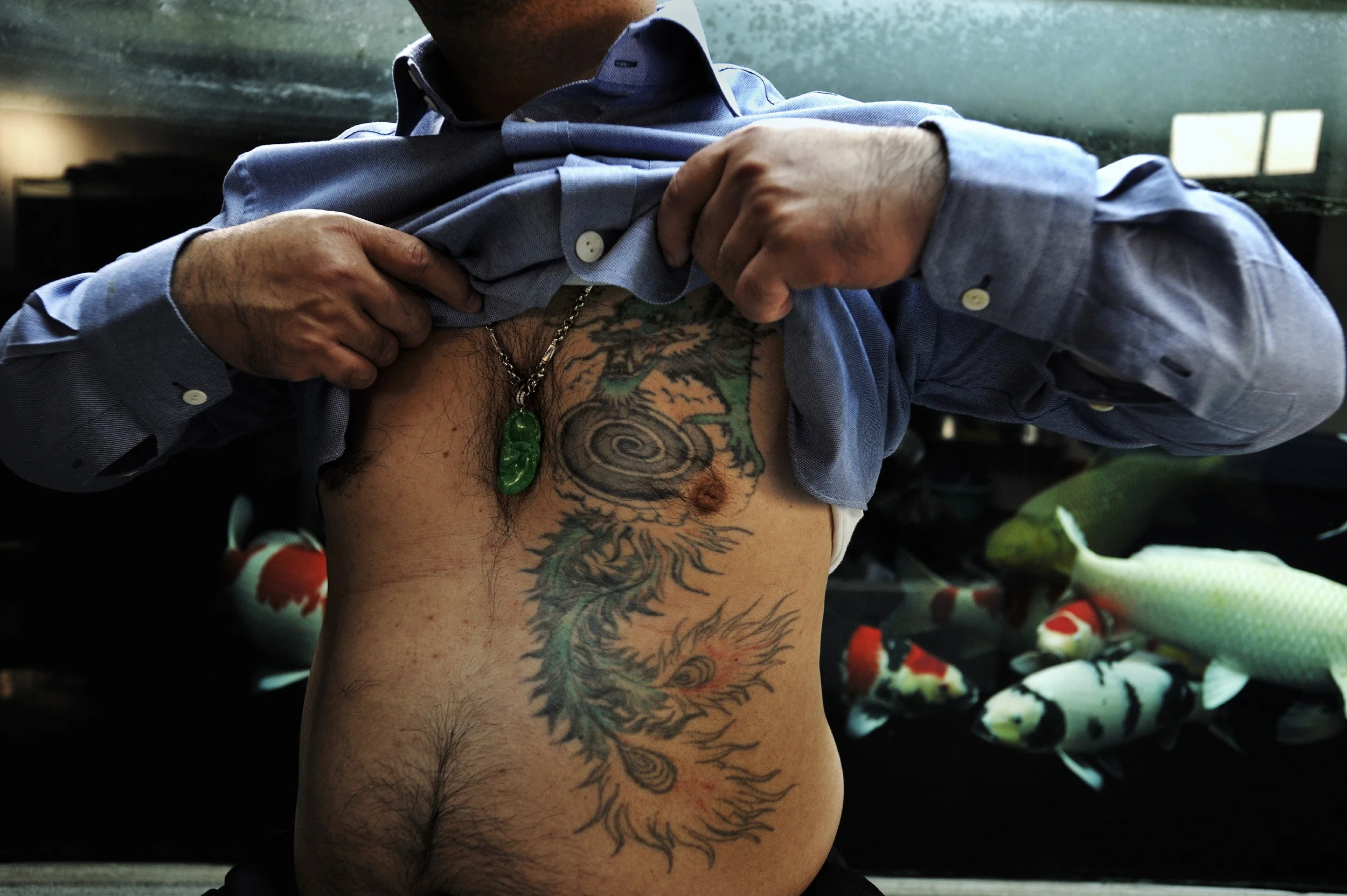  This retired "red pole" enforcer for Sun Yee On parted ways with the triad peacefully several years ago, but still has the phoenix-tailed dragon tattoo hidden under his shirt.  "Back in the old days," he says, "it was all about heart --about righteo