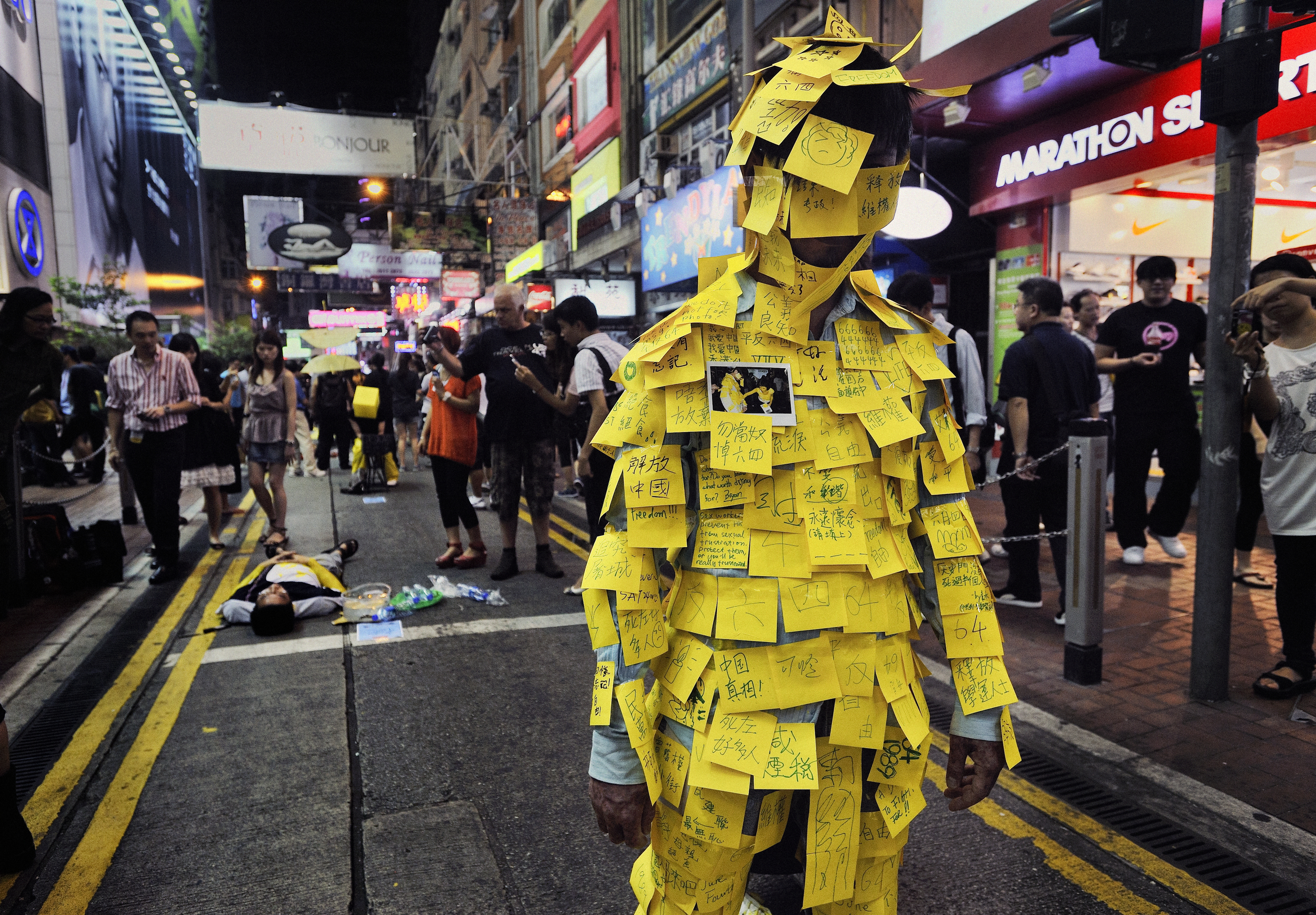  Hong Kong, 2011.  Artists do street performances commemorating the Tiananmen Square demonstrations that ended in a bloody crackdown twenty-two years previous 
