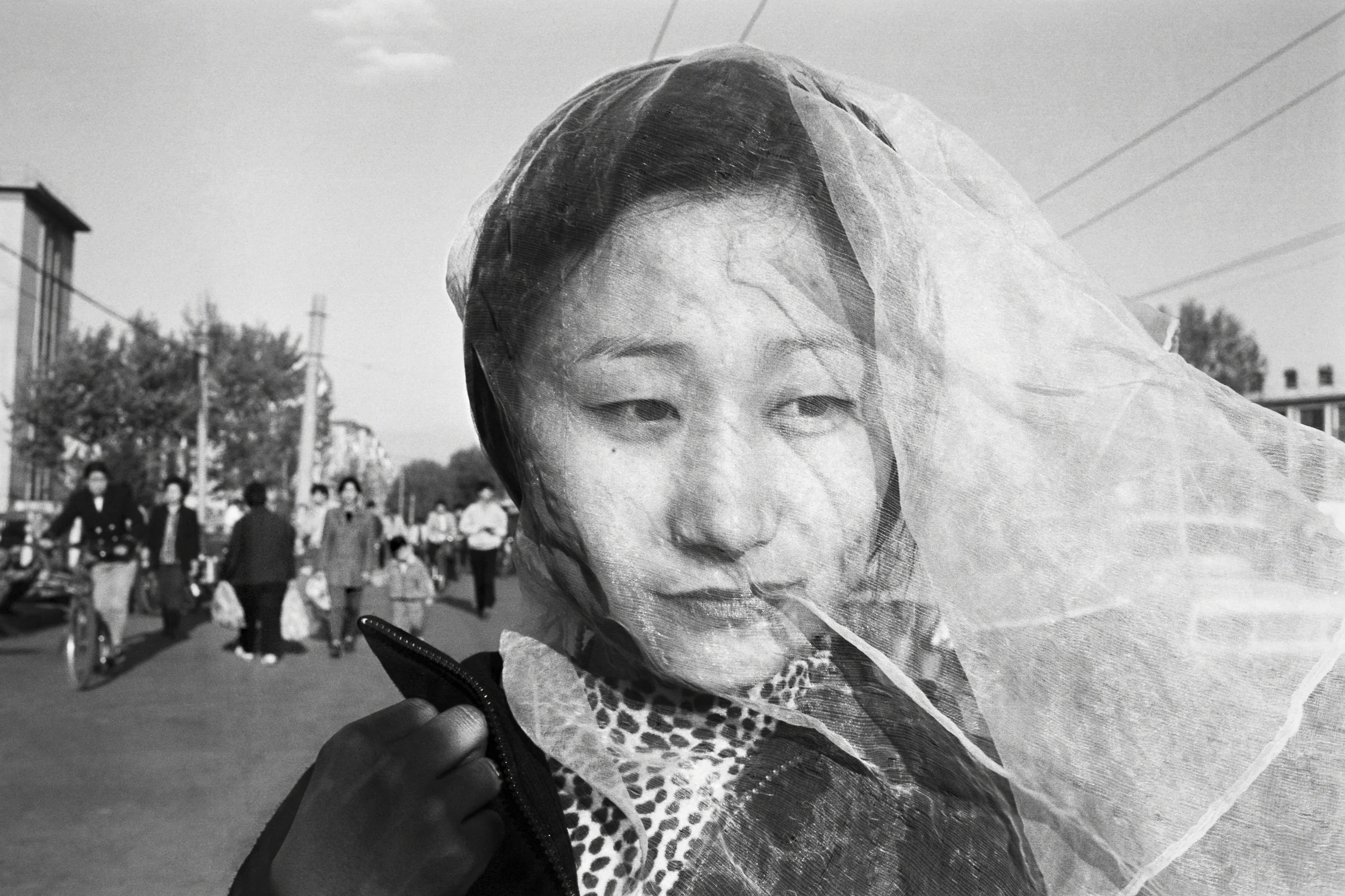  Shenyang, 1998. A woman wears a veil to keep coal dust out of her face in one of the world’s most polluted cities. 