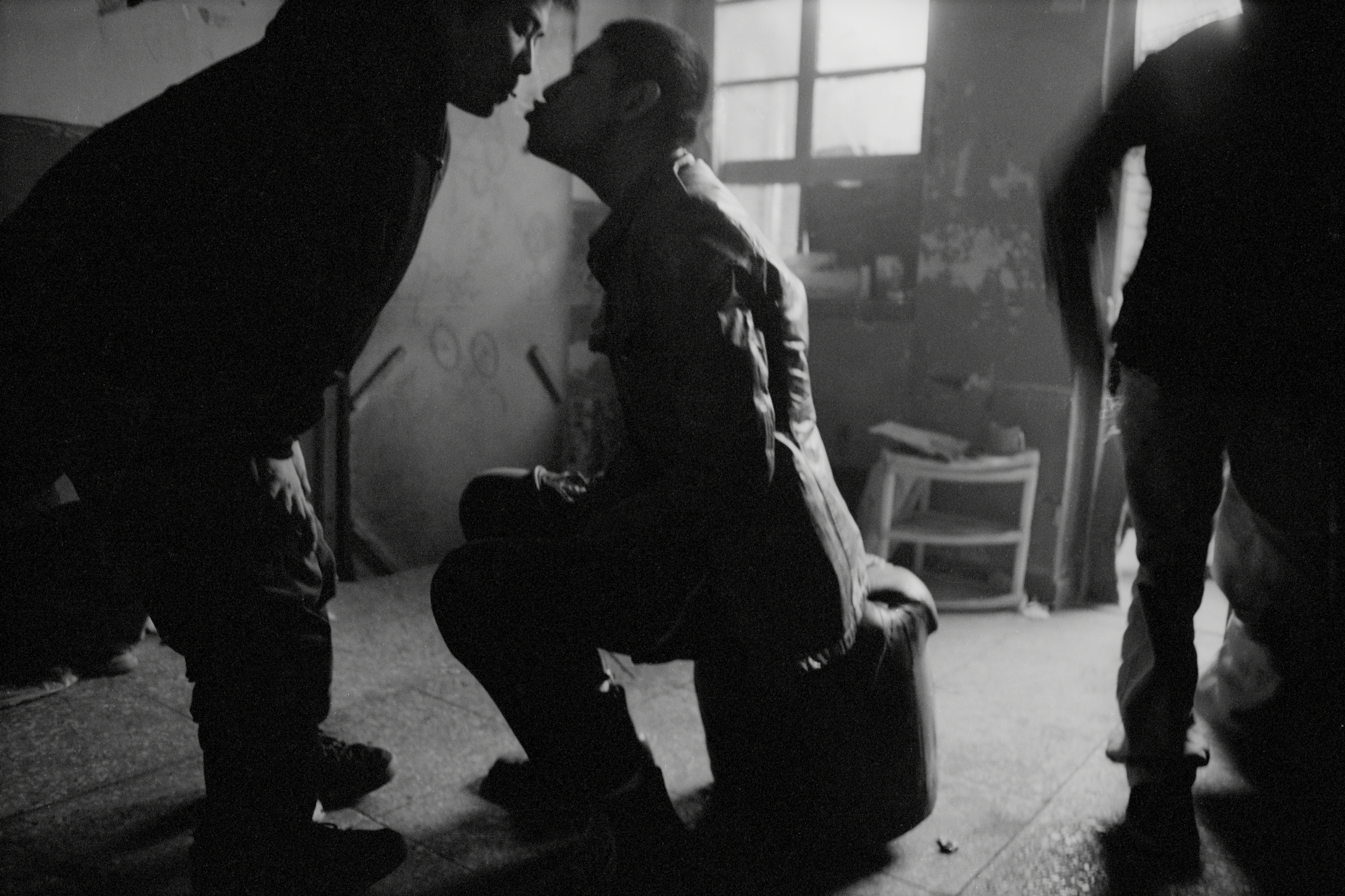  Beijing, 1998.  Punk bandmates share a puff of hash smoke.  
