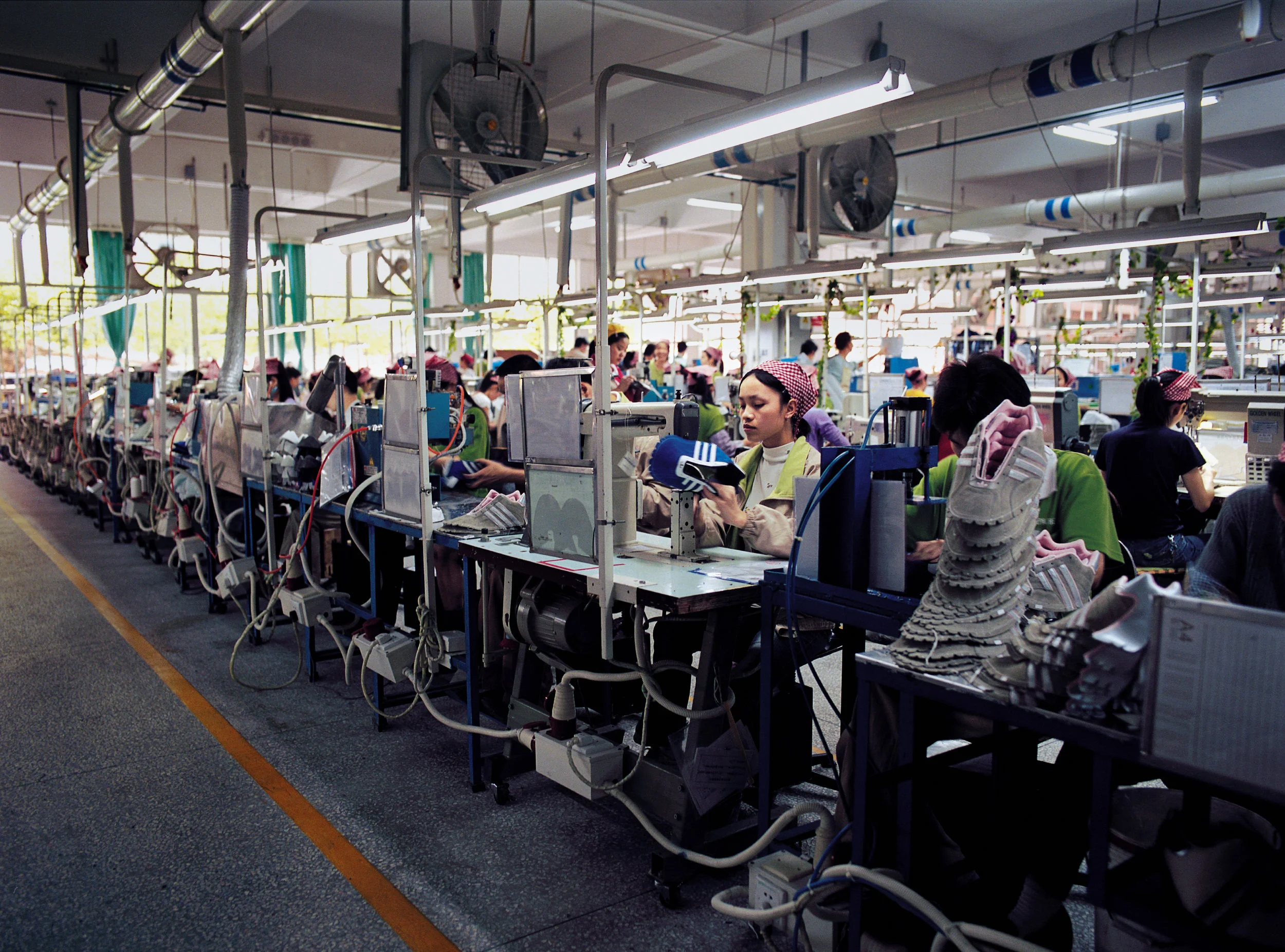  Guangzhou, 2005.  Migrant workers on an adidas assembly line  