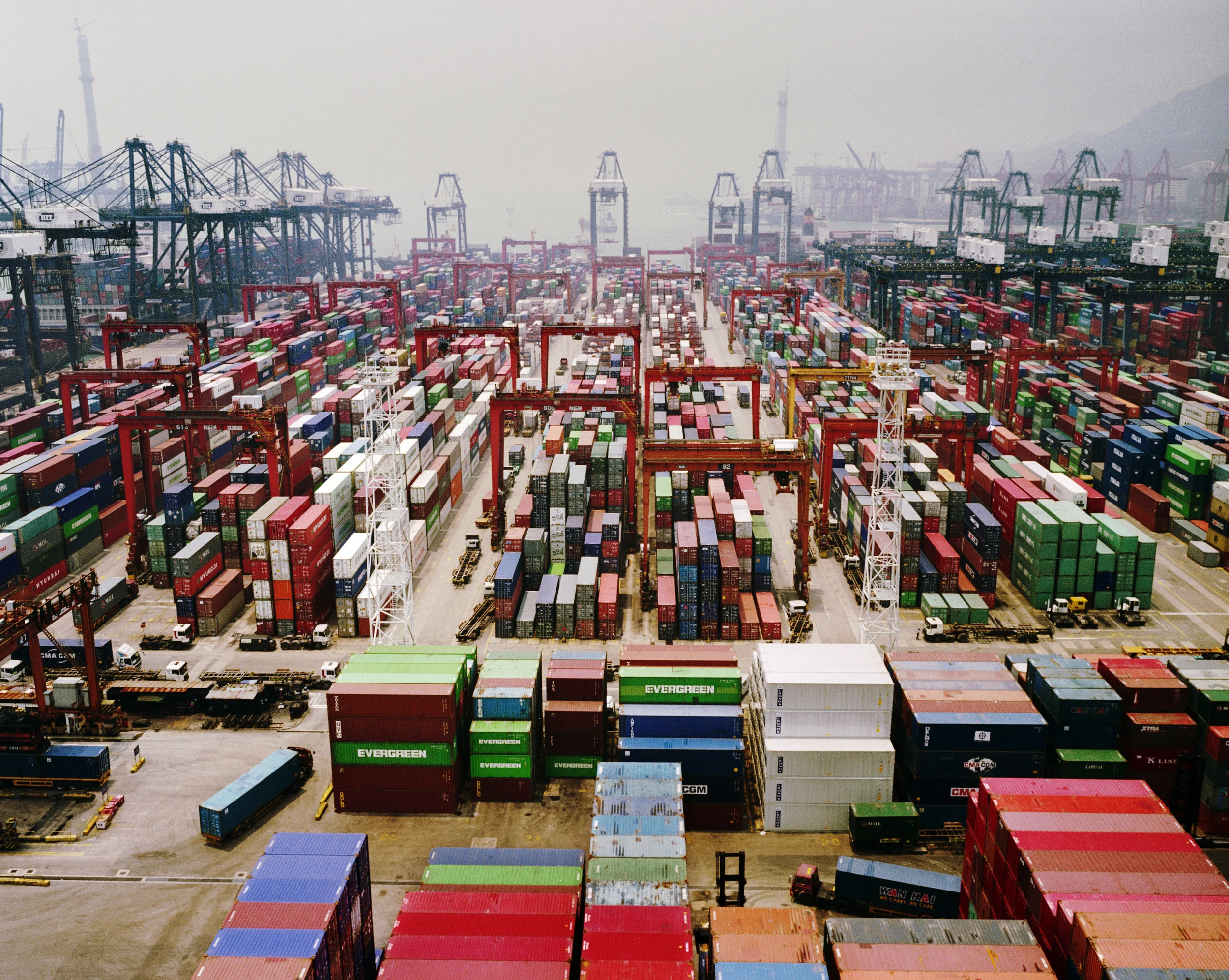  Hong Kong, 2004.  Container port of China-manufactured goods headed overseas.  Over time, shipping that almost all went through Hong Kong now goes out from mainland cities like Shanghai. 