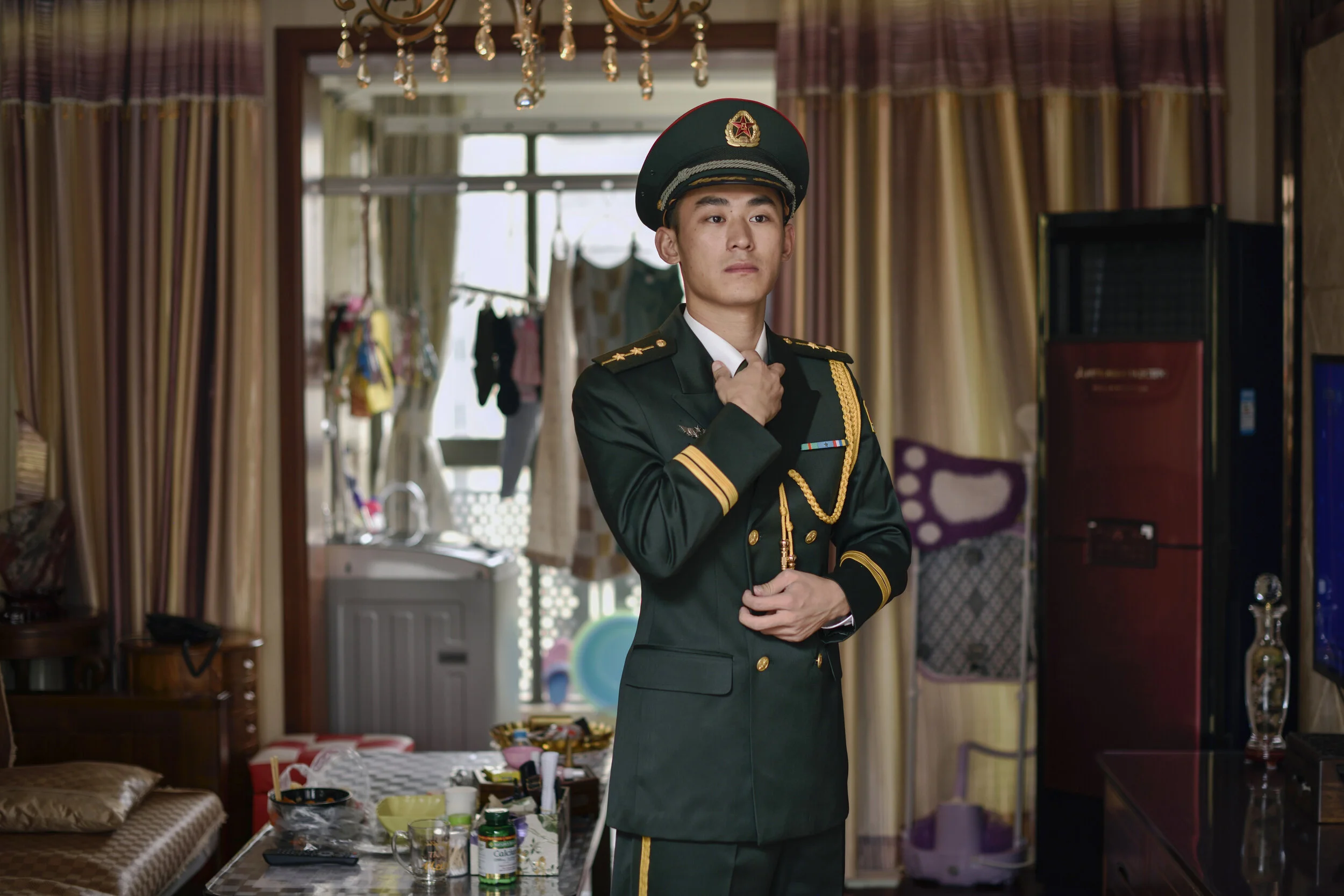  Shanghai, 2018.  Special forces soldier Fang in uniform on break at his parents suburban home.  He says as an elite leader he has to work with soldiers from different parts of the country, a skill he picked up when organizing raiding parties in the 