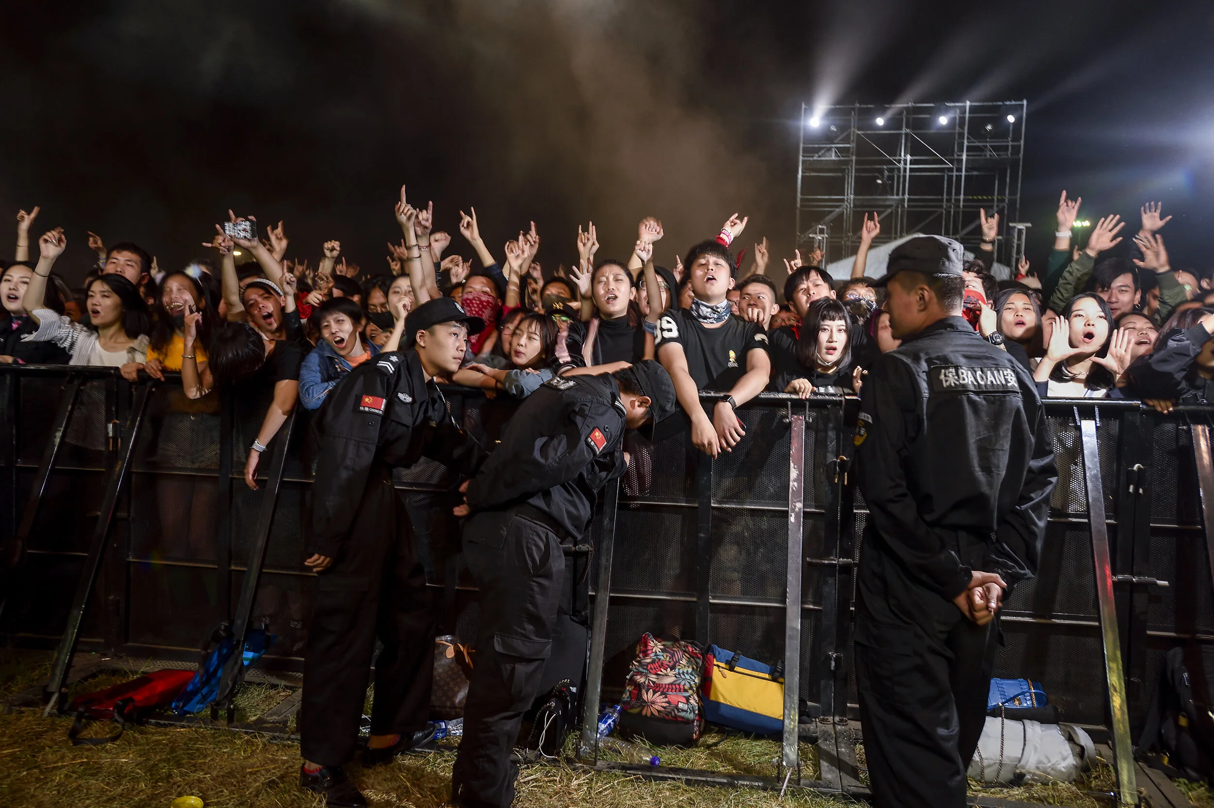  Beijing, 2018.  Hardcore fans of the rock band Reflector cheer for their idols at a music festival sponsored by a real estate company. 