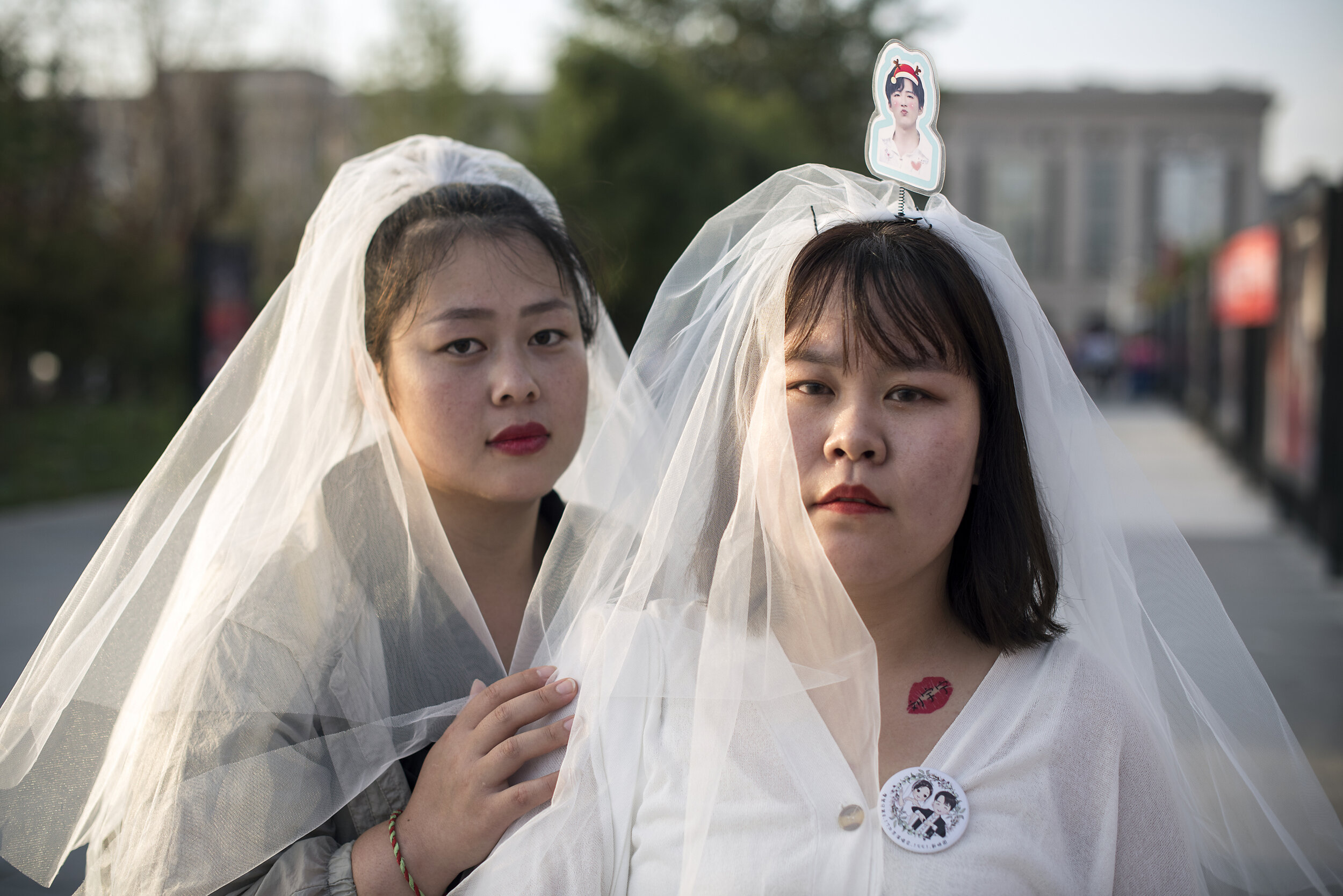  Beijing, 2019.  Fans of pop star Liu Yuning organized via WeChat to all dress as brides to attend a concert by their hero. 