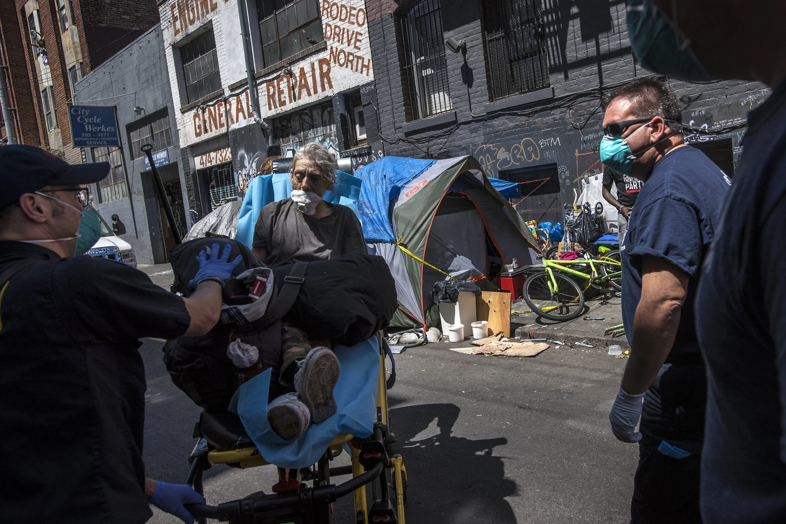 San Francisco Fire Department paramedics pick up a woman who overdosed on Willow St in the Tenderloin.    A policeman saw her lying motionless on the sidewalk, and alerted her neighbors who revived her with Narcan before the paramedics arrived.   Th