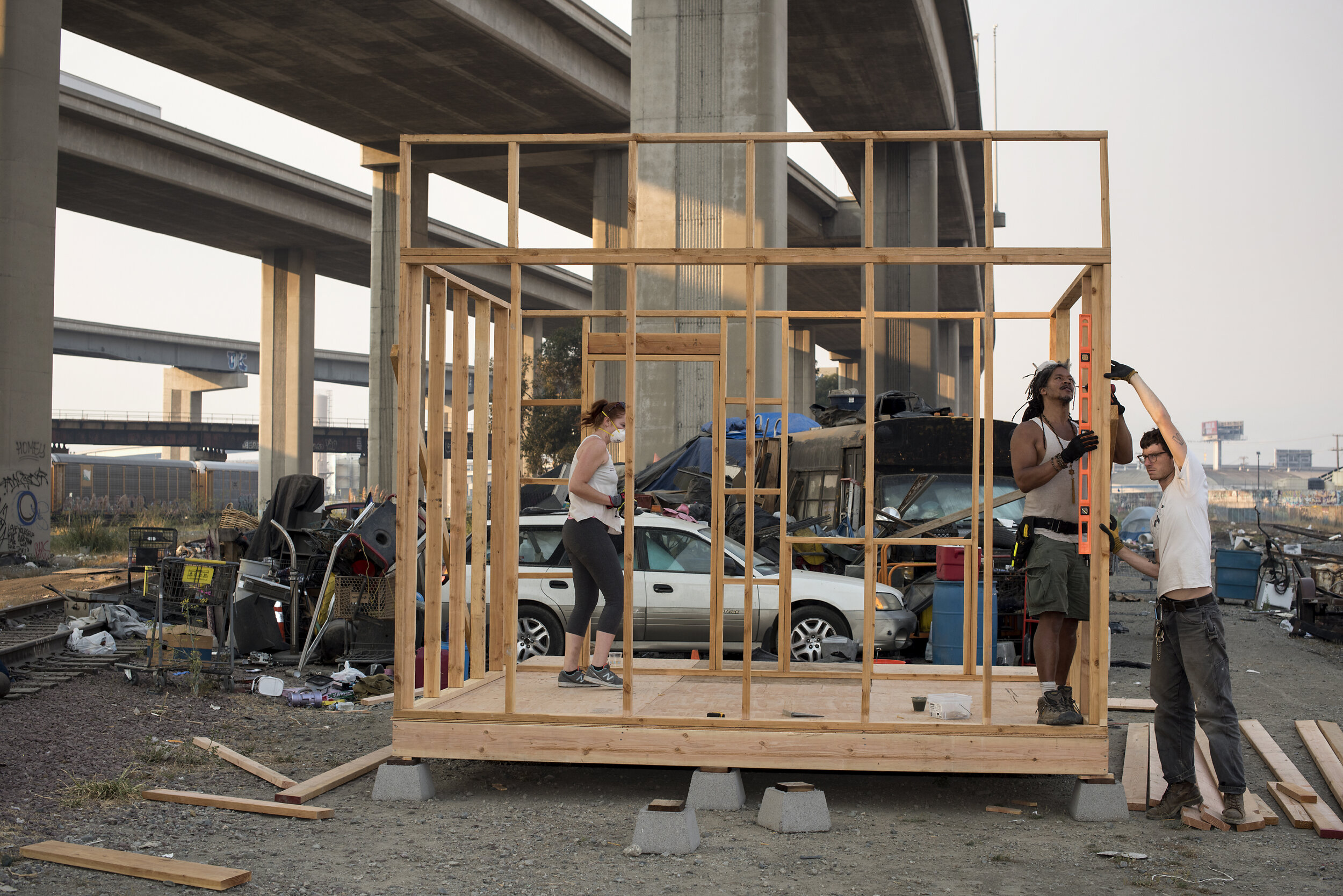  K, J and B volunteer with Artists Buildiing Communities to build a 10x10 foot tiny home (with a porch) for homeless resident of Wood Street in Oakland, Mona Choyce.  J, who designed the structure, is a professional theater set builder who is a curre