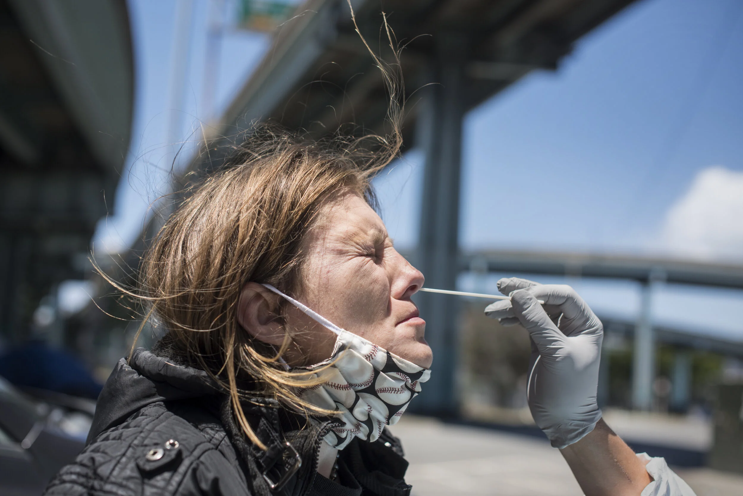 B, 38, who lives in a tent in front of San Francisco City Hall, gets swabbed for covid at a location on the other side of town.  She has been on the street for 10 years. 