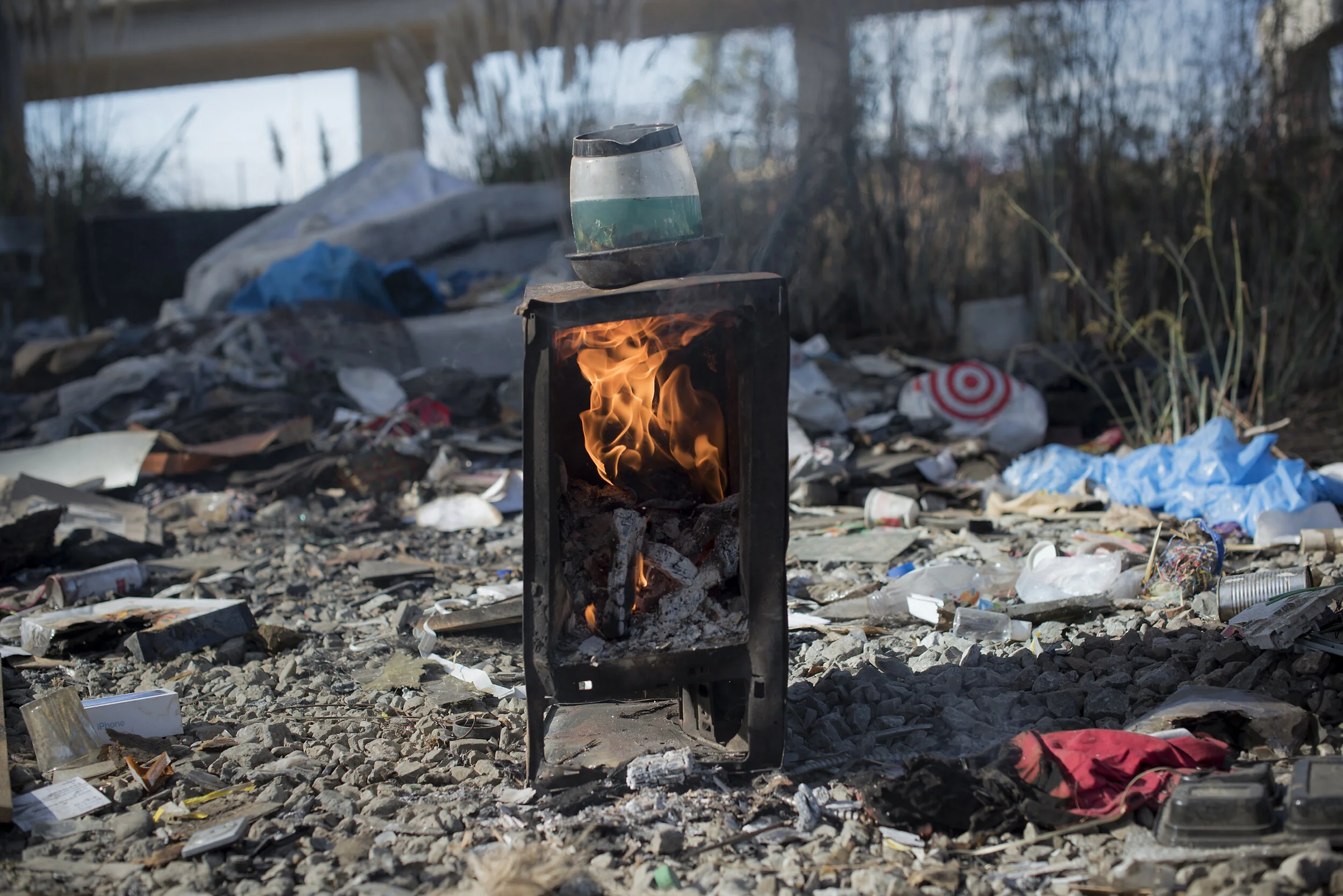  R, 34, had to stop working because of recurring hernia issues and now lives in an RV at Wood Street under the MacArthur Maze.  He is now trying to earn money slowly extracting precious metals from computer circuit boards by heating them in a pot of 