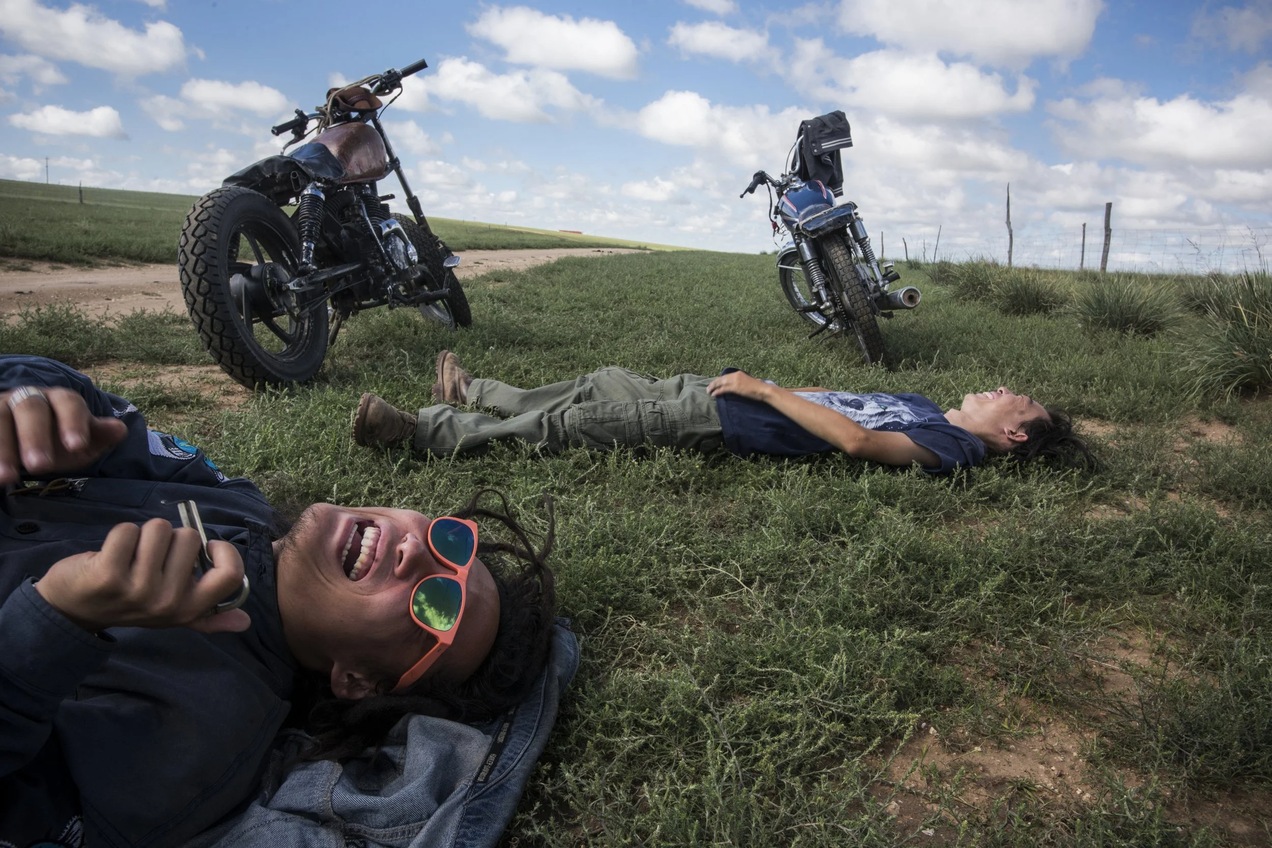  Inner Mongolia, 2019.  Da Fei and Lao Dai used to skateboard and listen to reggae in northeastern industrial Shenyang.  In a reversal of decades of rural to urban migration, they have fled the cities to roam the grasslands on their beat-up motorcycl