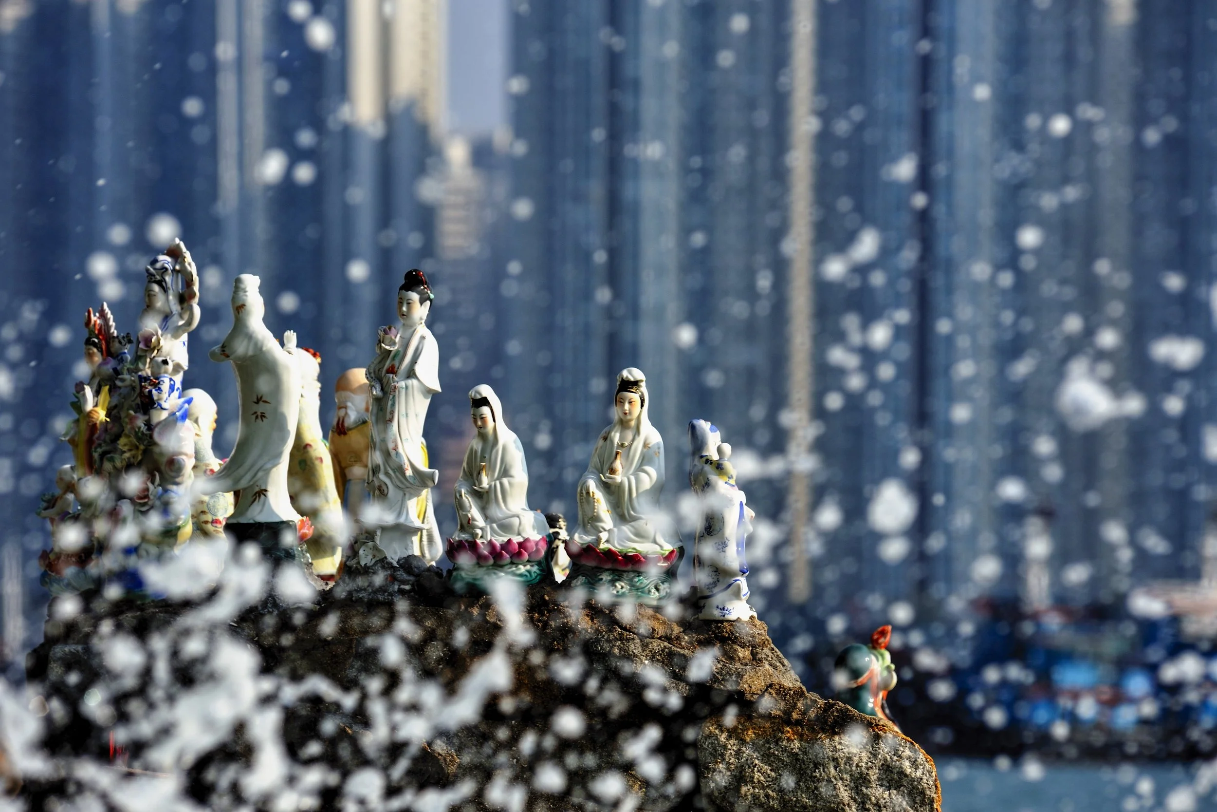  Hong Kong.  On the rocks besides Aberdeen Harbour, families have placed figurines of Guan Yin (Kwun Yam), the goddess of mercy, to protect loved ones at sea 