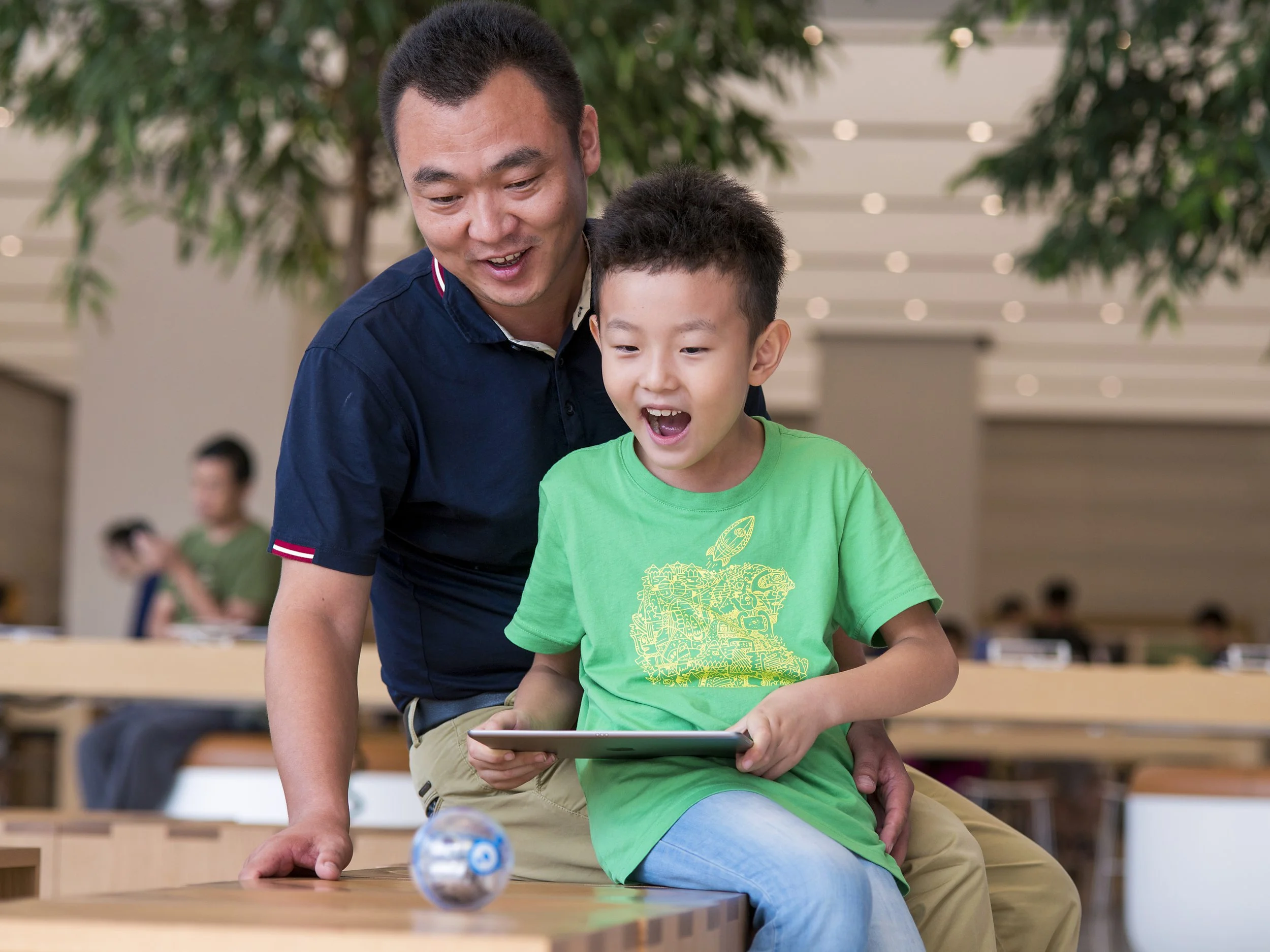  Apple.  Father and son at Apple Camp.  Jinan, China 