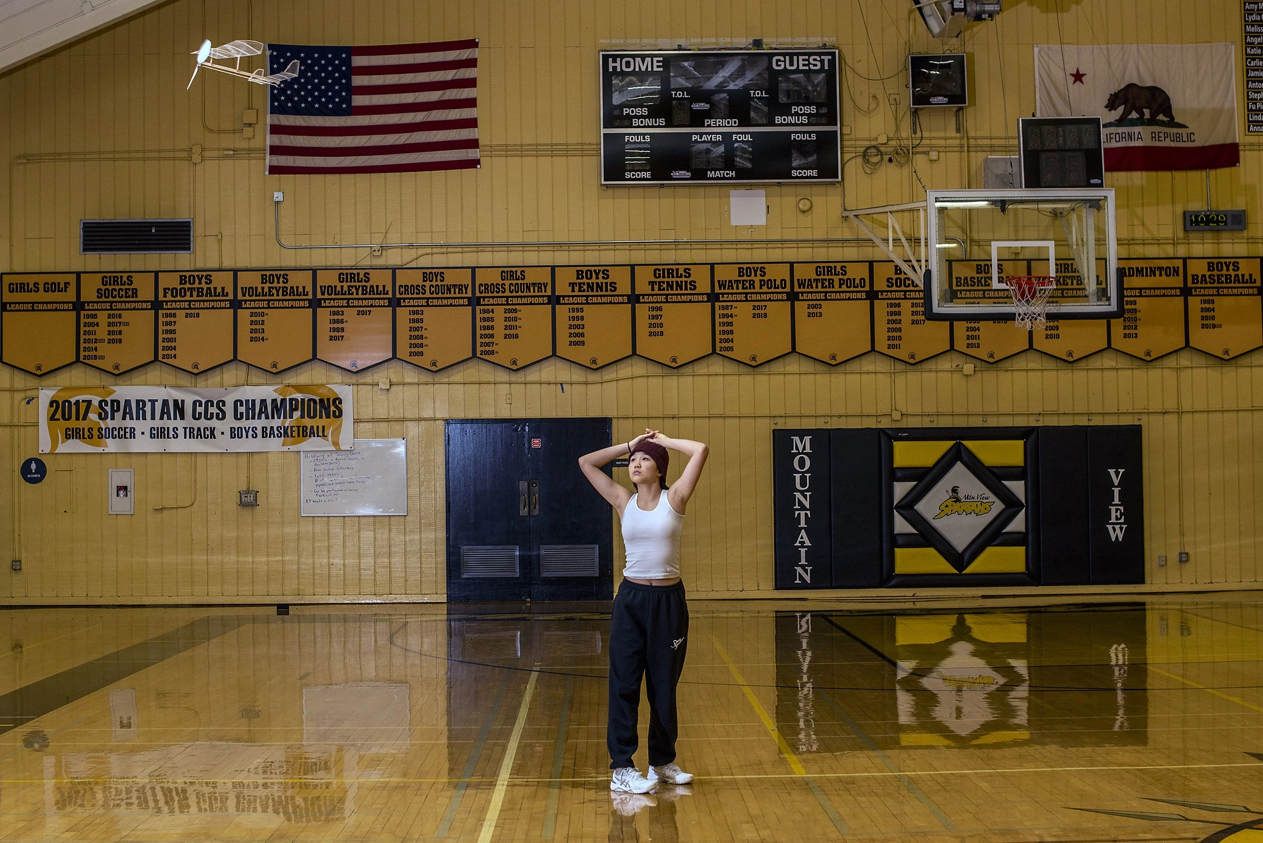  Mountain View, 2023.  Member of the Mountain View High School Science Olympiad Team prepares for the flight event, testing her airplane out in the school gym 
