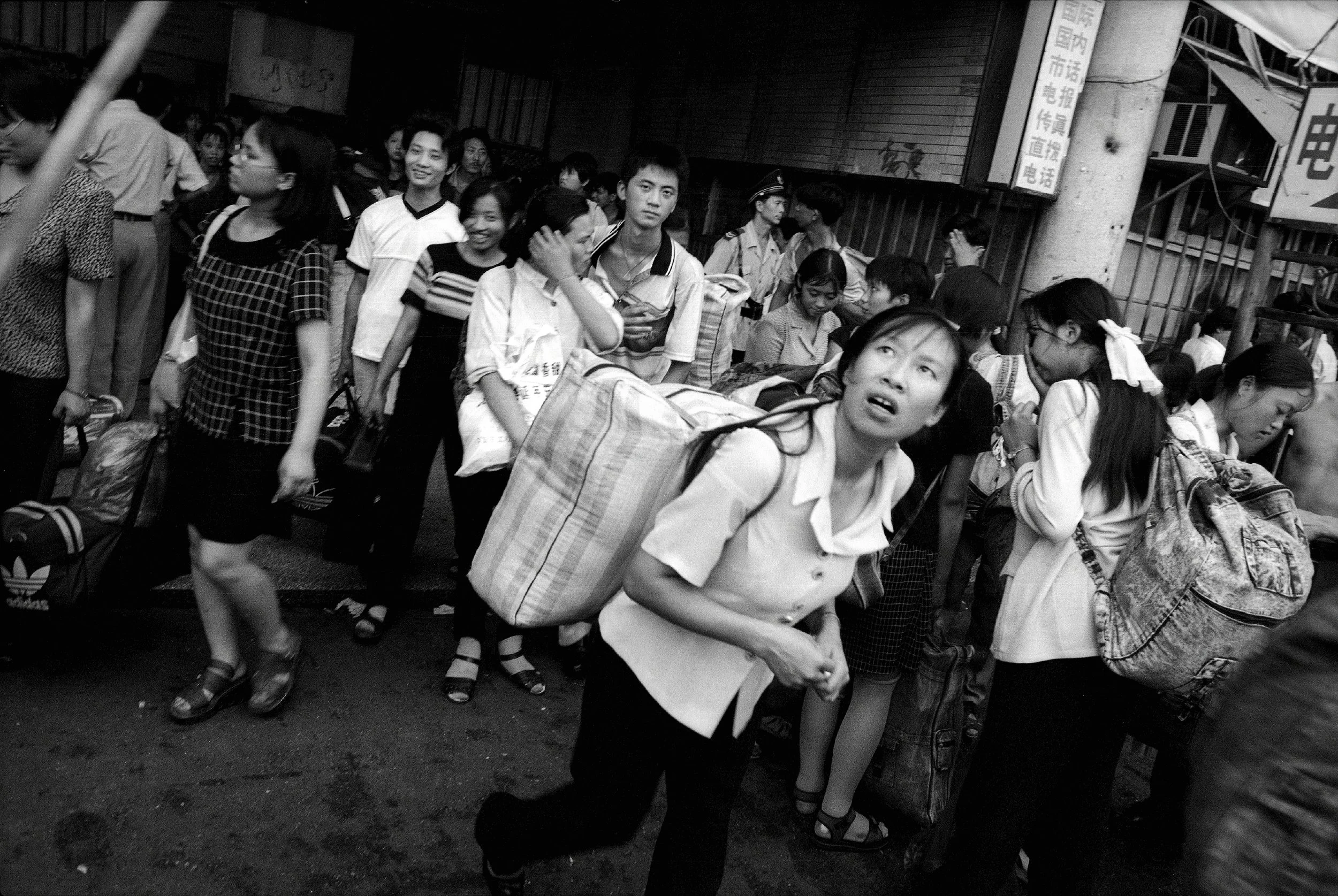  Guangzhou, 1997.  Newly arrived young people from the countryside emerge from the train station, looking for jobs in the big city but sometimes falling victim to thieves, cheats and kidnappers 