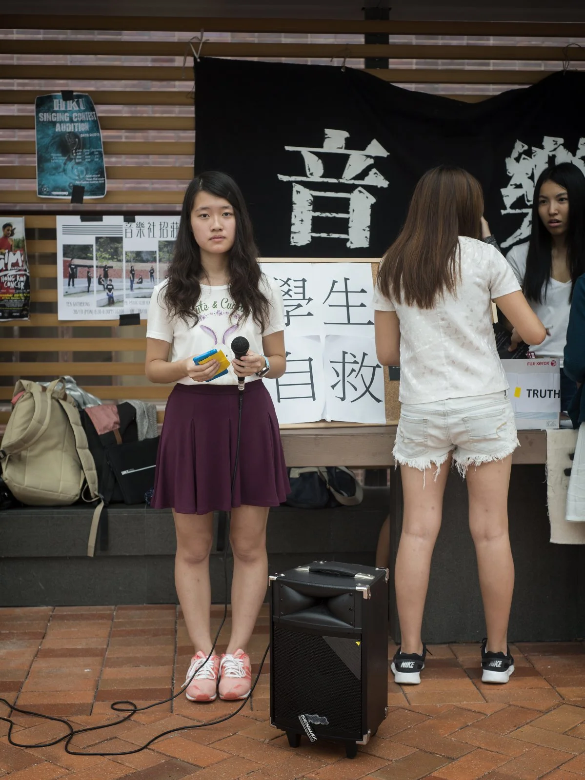  Hong Kong, 2015.  A year after the first phase of the pro-democracy Umbrella Movement, a HK University student calls for others to attend an assembly supporting academic autonomy 