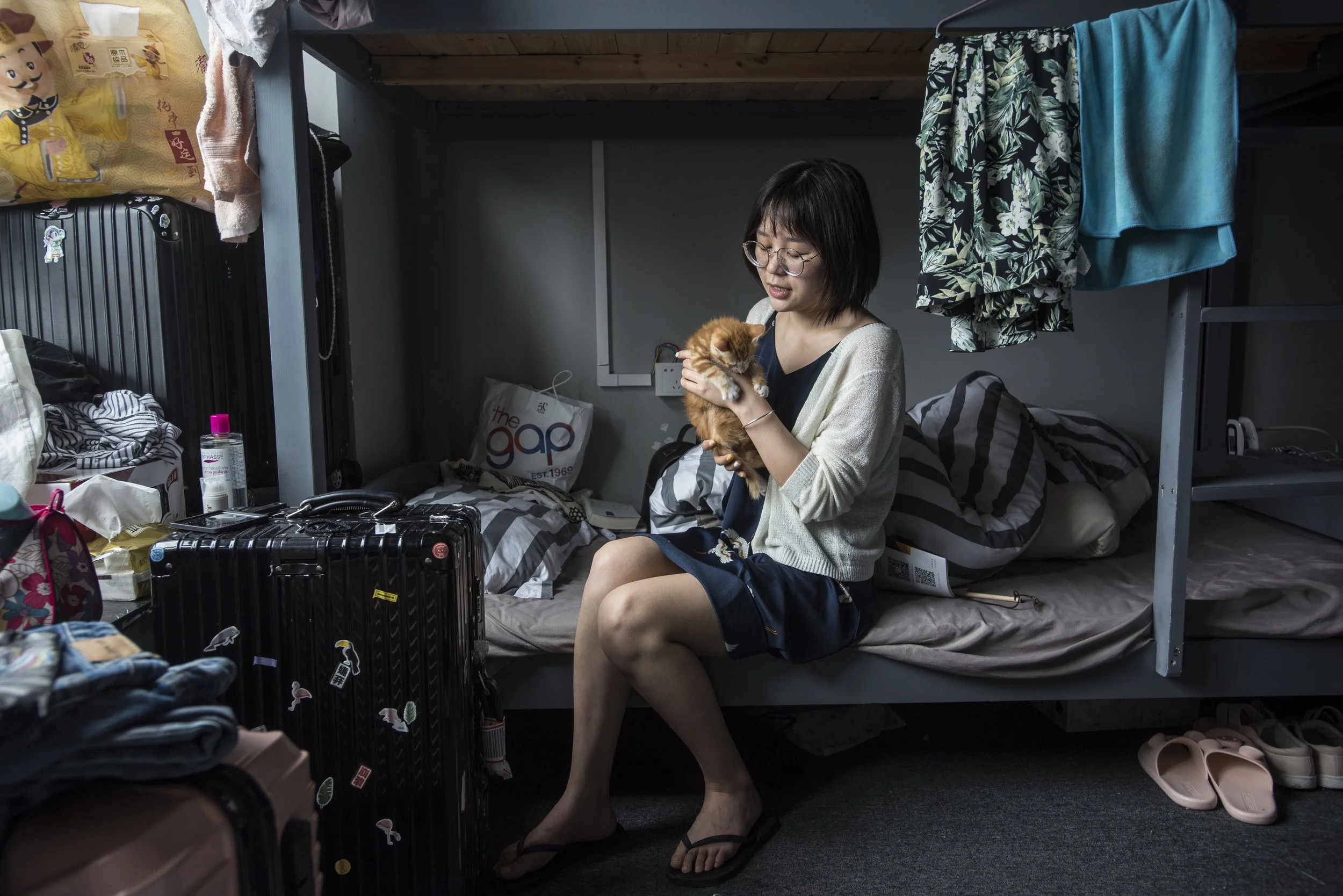 National Geographic.  Modern migrant worker stays in dorm room while she seeks employment.   Shenzhen, China 