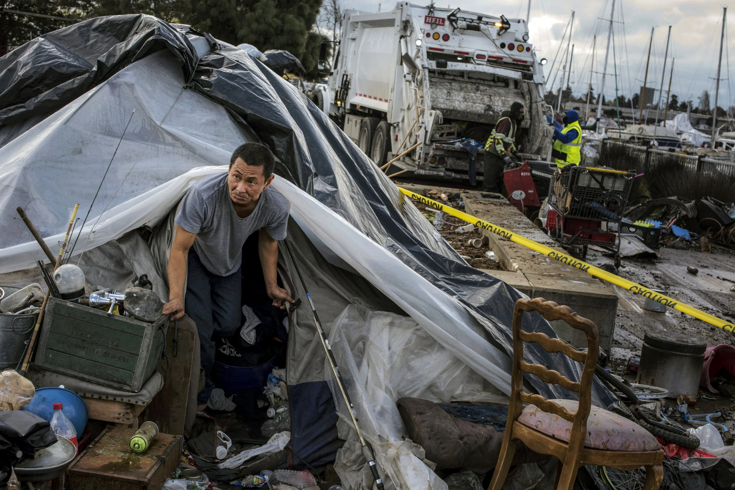  J scrambles to move his belongings out of his tent minutes before city bulldozers and garbage trucks raze the dwellings on the Union Point marina. This encampment was home to unhoused residents for more than ten years until March 2021 after Oakland 