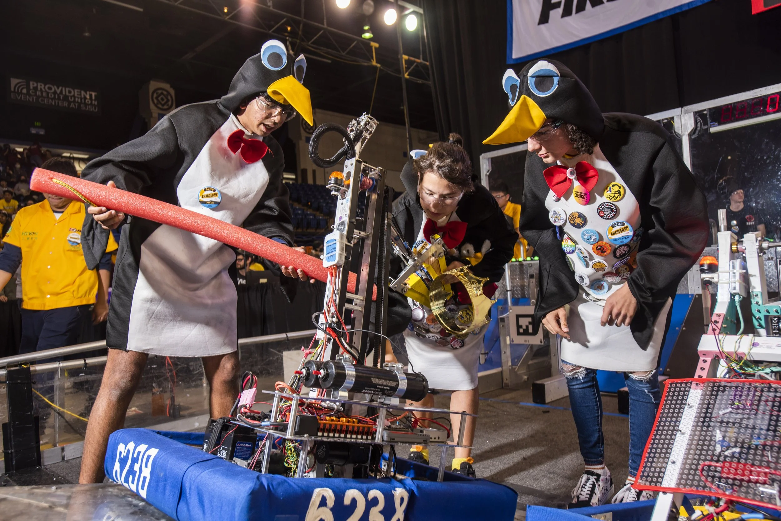   Bay Area High School STEM Competitors.  San Jose, 2023. At the 2023 FRC Silicon Valley Regional, community-based Team 6238 Popcorn Penguins bring their robot into the playing area and ready it for competition. At the end of the day, they take home 