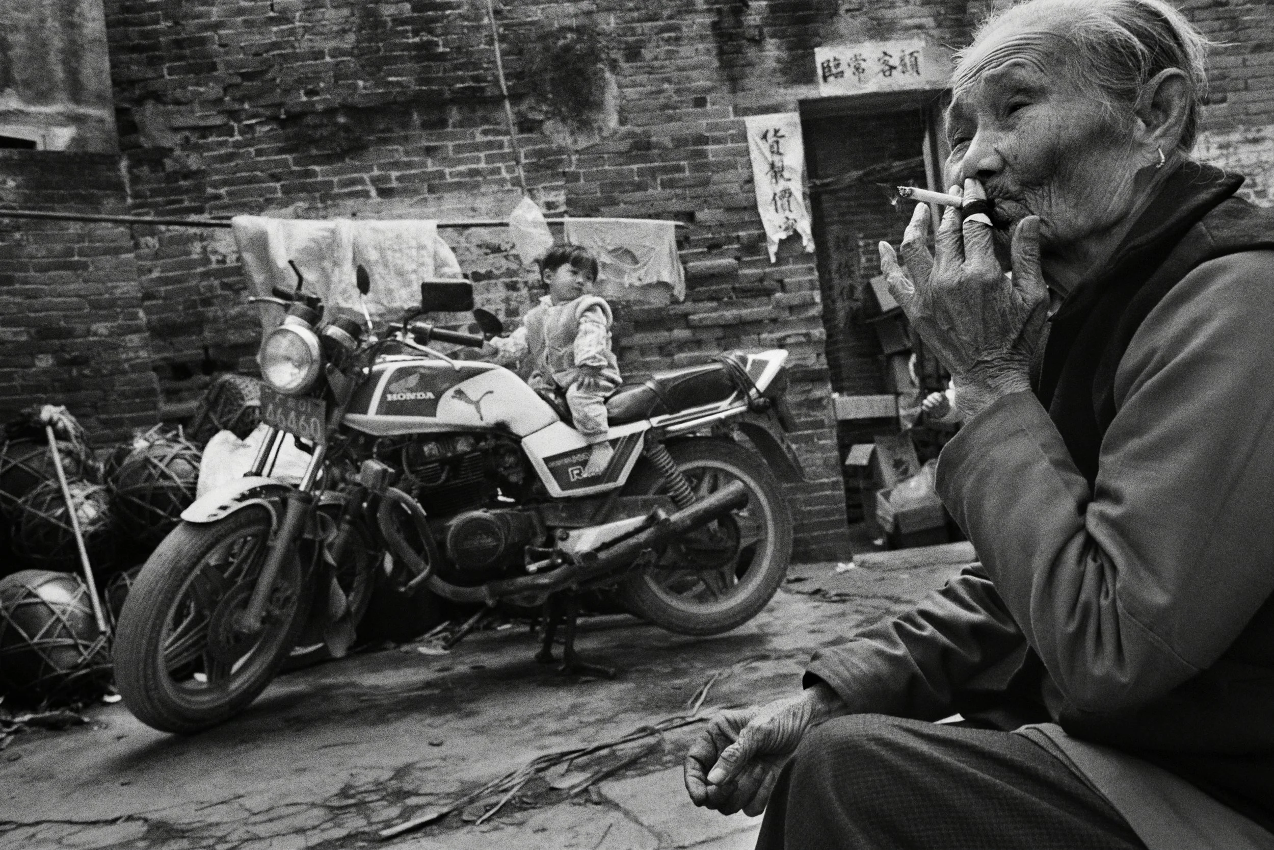   China Obscura is a book that collects my black and white work documenting China between 1989 and 2003. Published in 2004 by Chronicle Books   Shunde, 1990. In my father's ancestral village, an imported motorcycle bought on the black market expanded