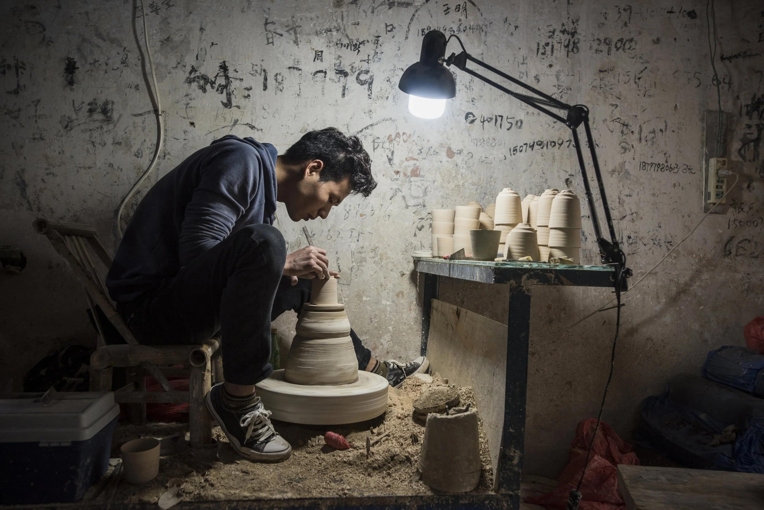  China Youth . Jingdezhen, 2019. Going against decades of rural-to-urban migration flow, this pottery master left a Suzhou factory job manufacturing iPad cases to return home and make porcelain teacups 