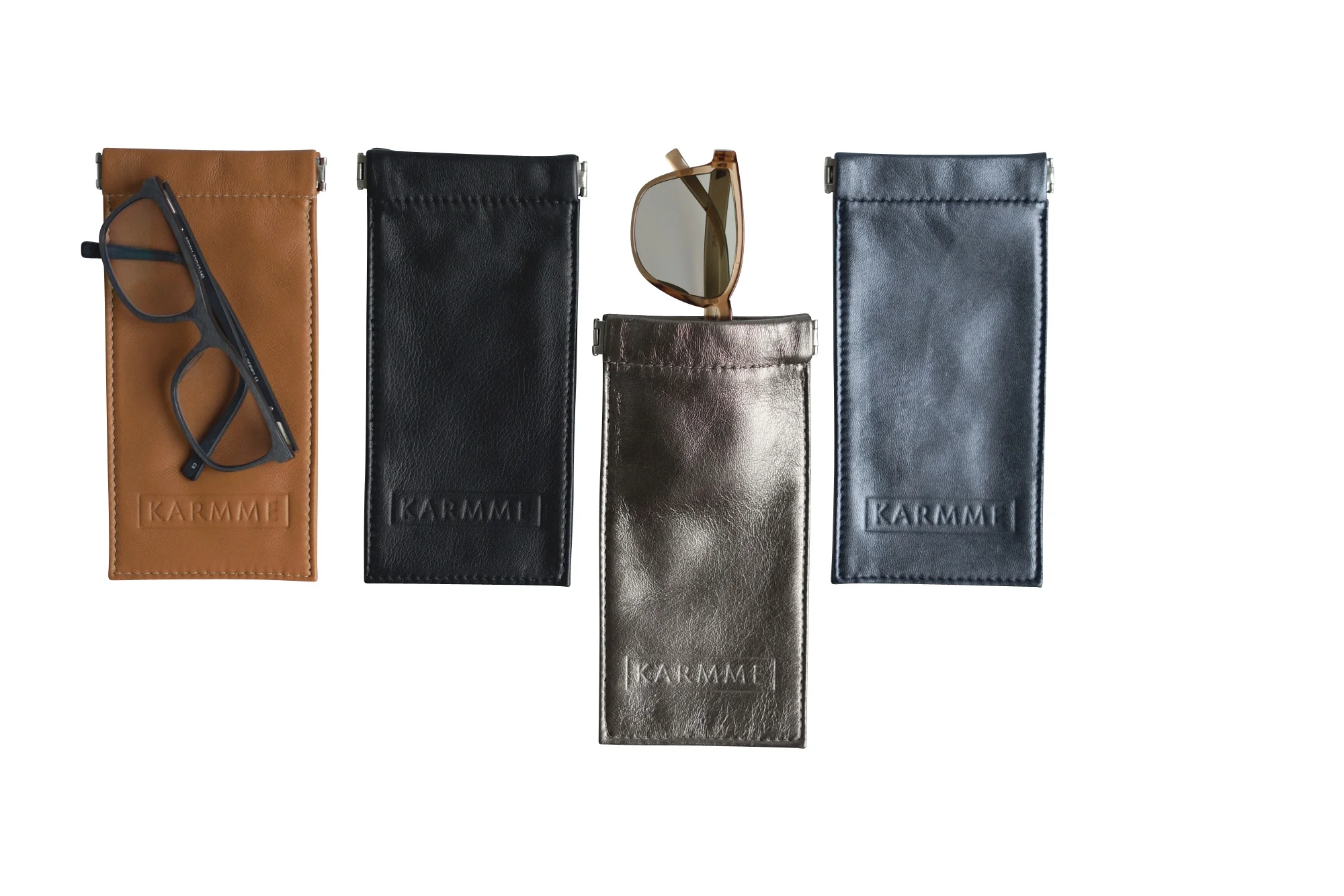 Four KARMME leather sunglass pouches in black, brown, blue and grey.