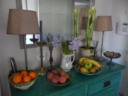 On my Annie Sloan painted mahogany sideboard in the kitchen is a vintage jug with beautiful blue/mauve hyacinths and a white Amaryllis which has the first of three flowers about to burst open.