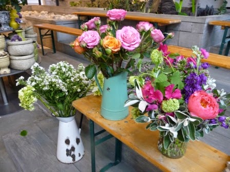 Some of the vases of flowers on the stand. Love the roses