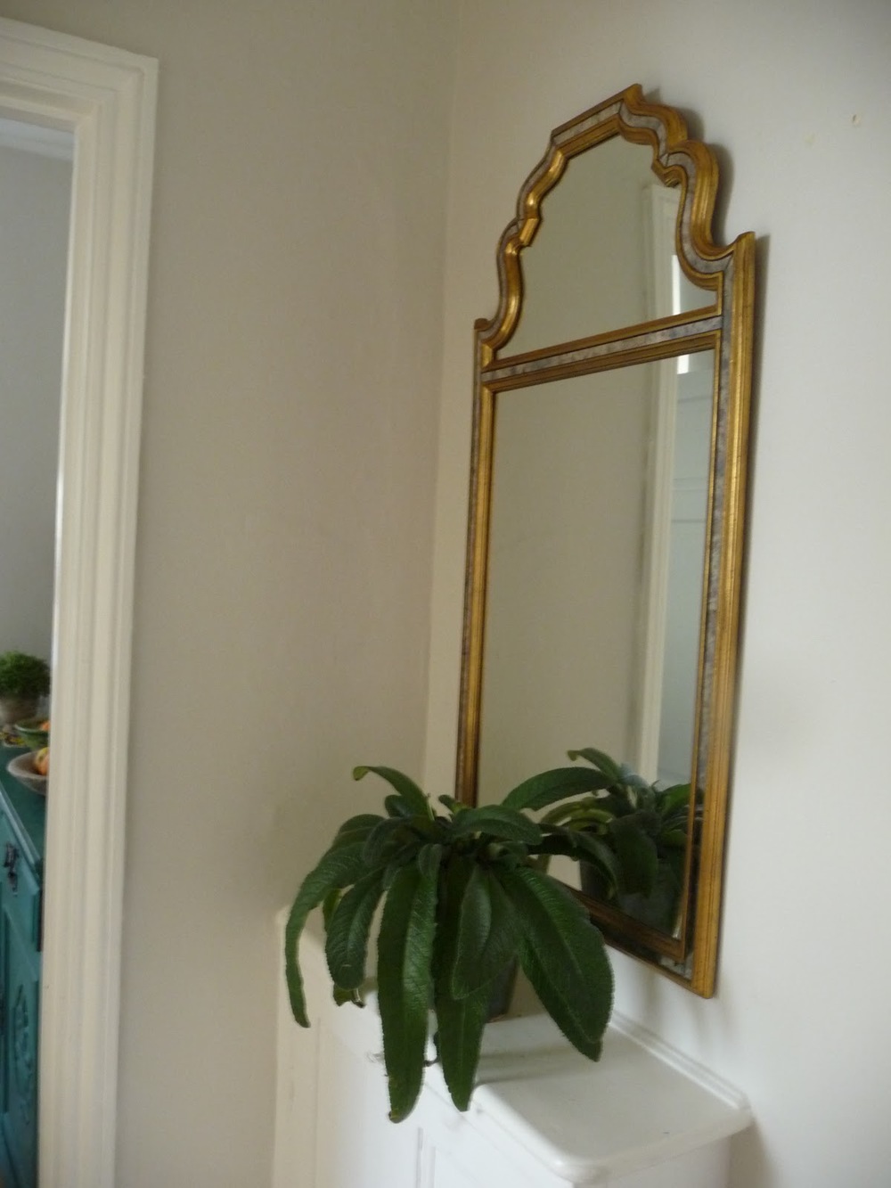 I found this mirror in a second hand book shop of all places. It is made in Belgium and is rather unusual. It is placed opposite the bathroom so reflects light from the bathroom window
