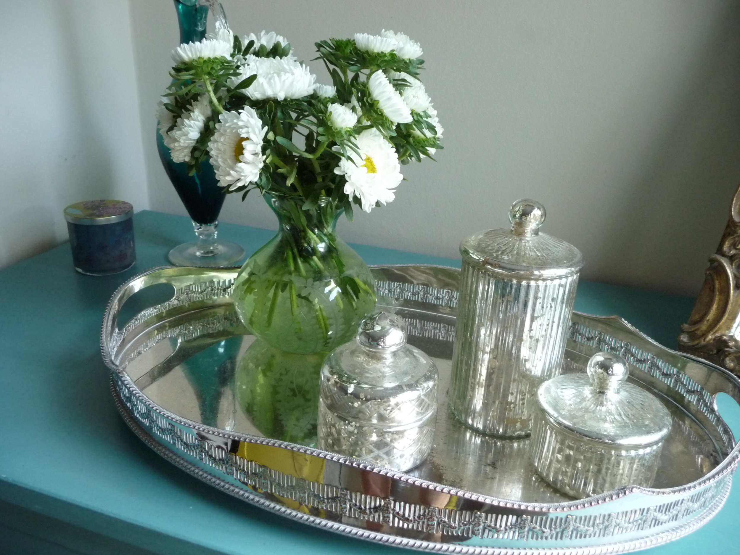  The white Asters whose offshoots are in the vintage bottles.&nbsp; Note the vase as a small neck but wide base which means you can splay the flowers out better 