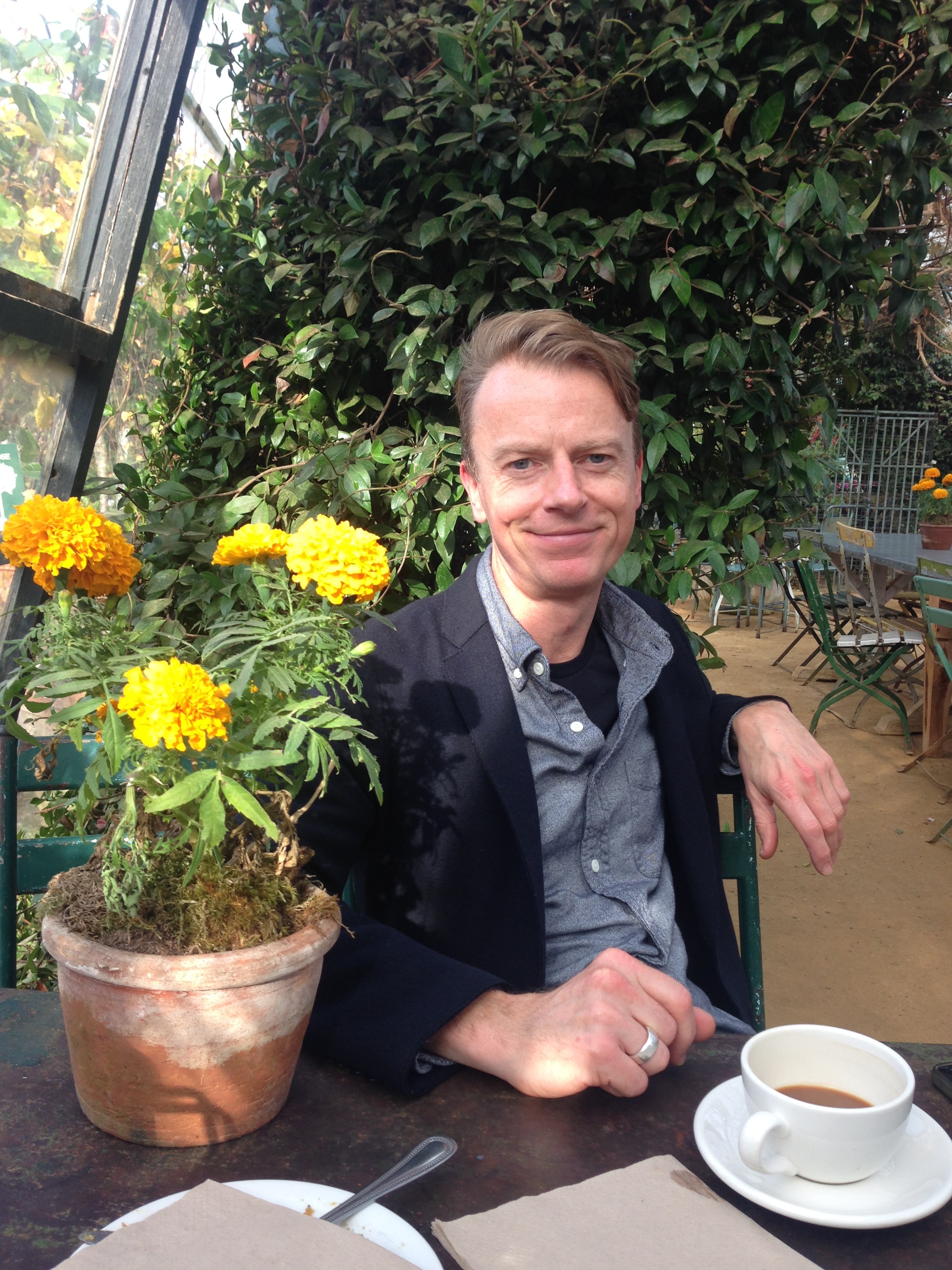 My friend Nick in the glasshouse where we were having coffee and cake.&nbsp; I am not a lover of marigolds but a terracotta pot of them on the table looked gorgeous 