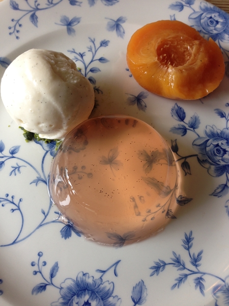 Dessert of peach jelly, poached peaches and vanilla ice-cream