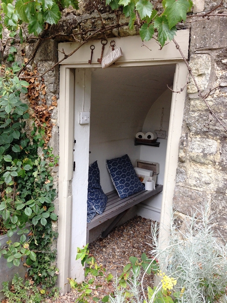 The loo for outside guests - the actual loo is behind the door. Love the way the gravel continues inside