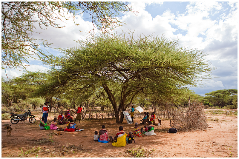 This local community send their children to school under a tree. While the children learn, the mothers sit and watch a chant along, learning their alphabets and counting. 