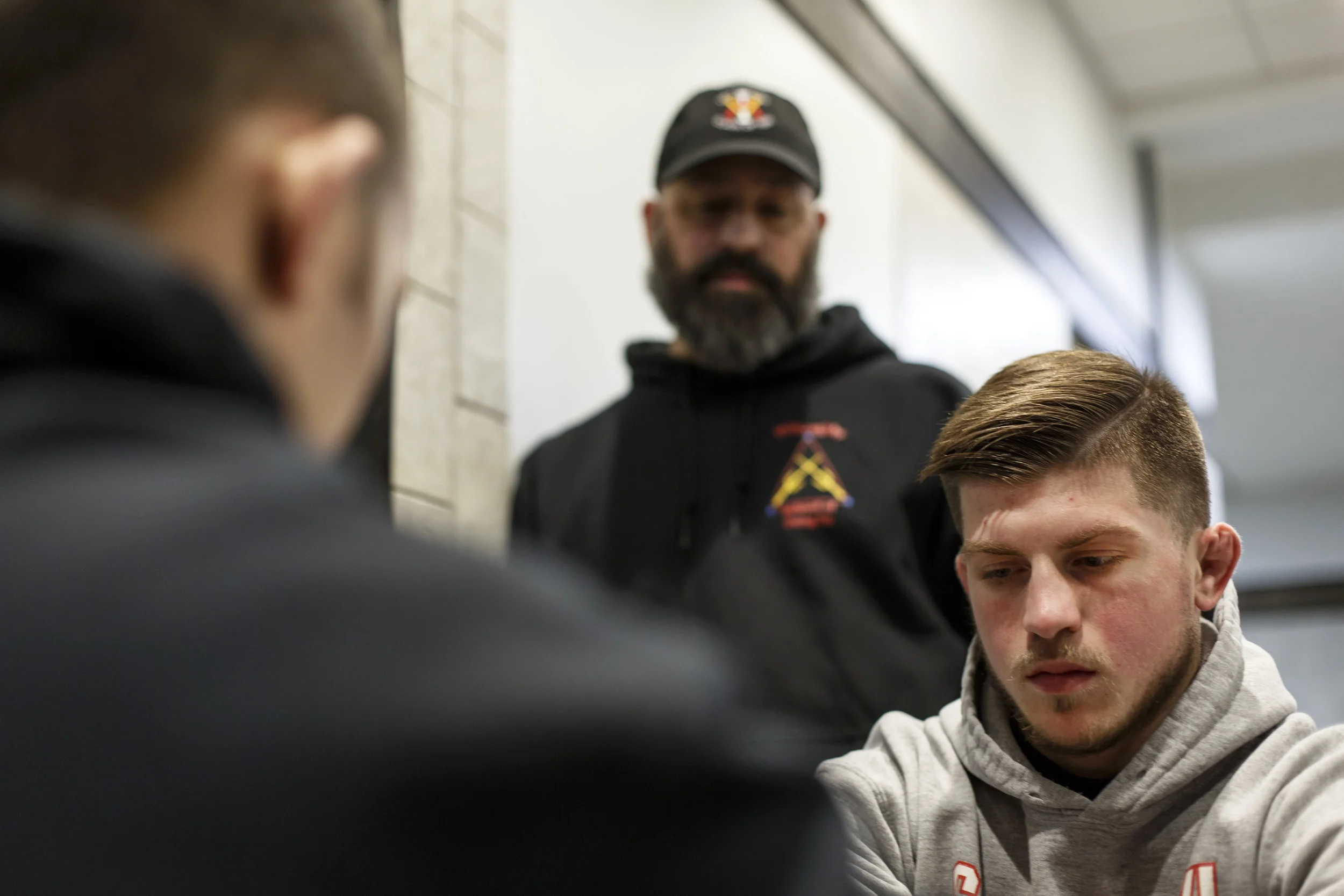 Nikolai Gionti quietly thinks while head coach, Jason Dent, wraps Nikolai's hands before his bout at the Goodyear Hall in Akron, Ohio on Wednesday, Nov. 23, 2016. The down time before a fight is what Gionti struggles with. 